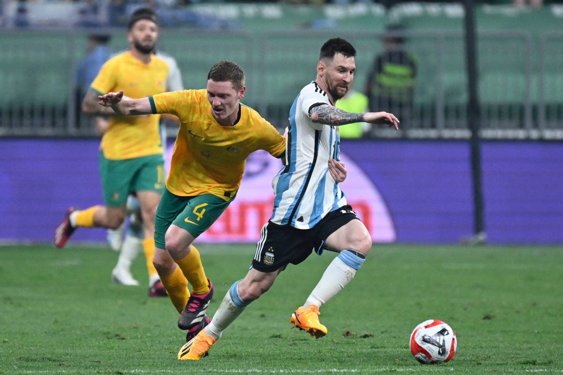 Argentina's Lionel Messi (R) fights for the ball during a friendly football match against Australia at the Workers' Stadium in Beijing on June 15, 2023. (Photo by WANG Zhao / AFP) (Photo by WANG ZHAO/AFP via Getty Images)