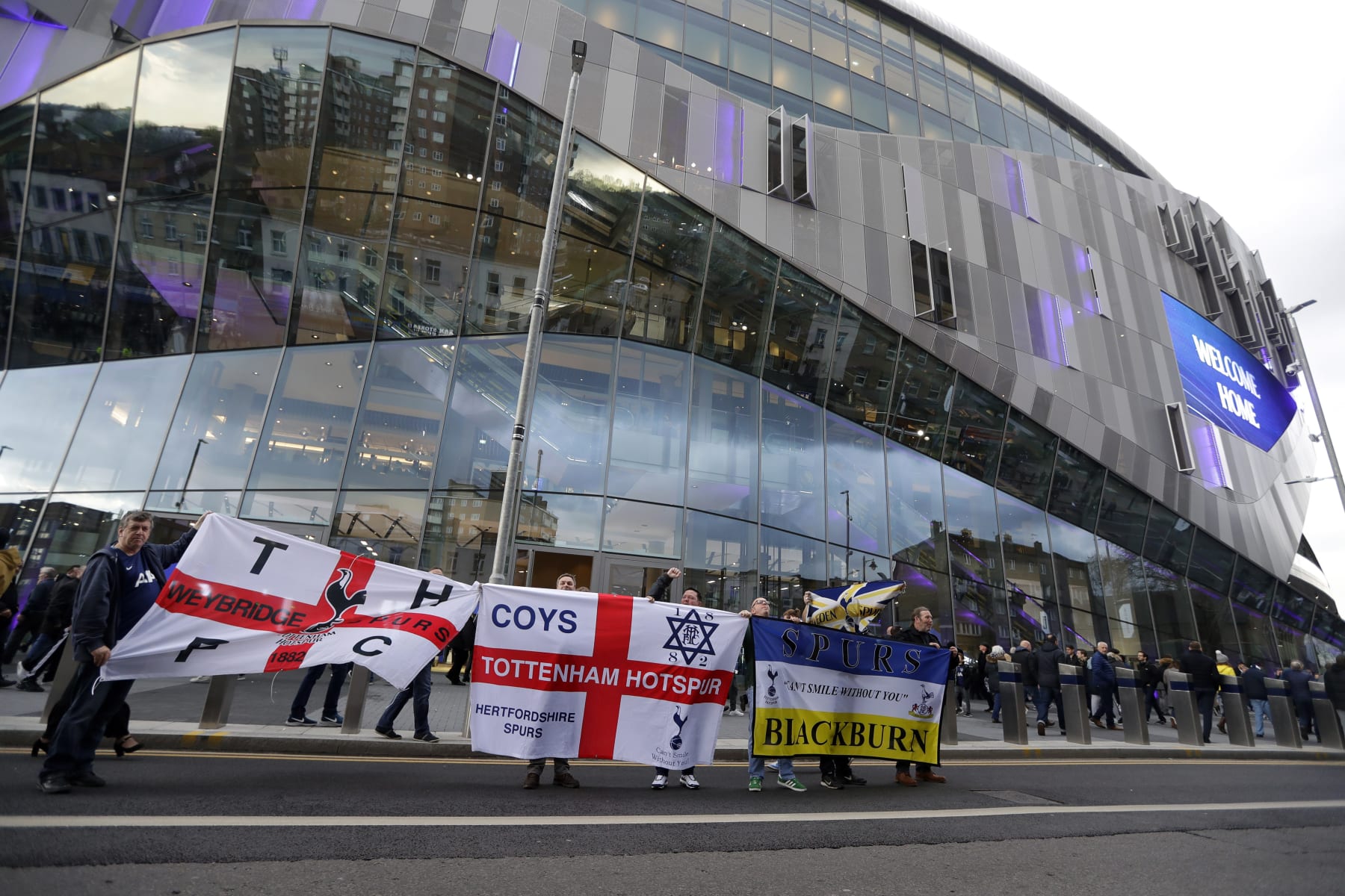 Tottenham fans display their banners outside the new Tottenham Hotspur stadium ahead of the English Premier League soccer match betweenTottenham Hotspur and Crystal Palace, the first Premiership match at the new stadium in London, Wednesday, April 3, 2019. (AP Photo/Kirsty Wigglesworth)