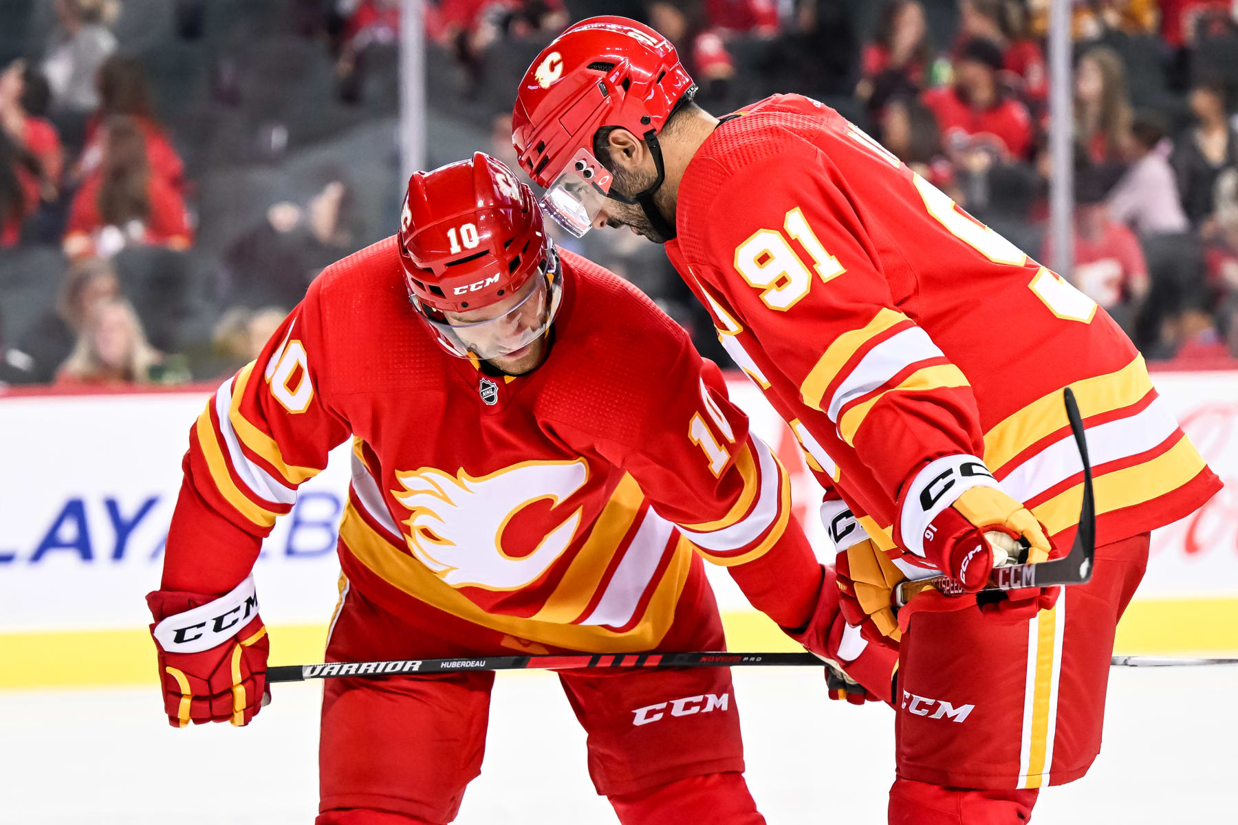CALGARY, AB - OCTOBER 07: Calgary Flames Left Wing Jonathan Huberdeau (10) and Calgary Flames Center Nazem Kadri (91) talk strategy ahead of a face-off during the second period of an NHL pre-season game between the Calgary Flames and the Winnipeg Jets on October 7, 2022, at the Scotiabank Saddledome in Calgary, AB. (Photo by Brett Holmes/Icon Sportswire via Getty Images)