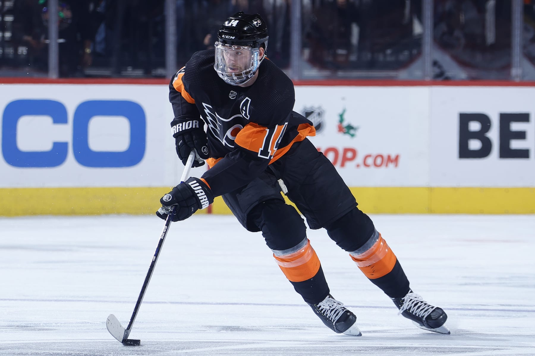 PHILADELPHIA, PENNSYLVANIA - DECEMBER 18: Sean Couturier #14 of the Philadelphia Flyers skates with the puck against the Ottawa Senators at Wells Fargo Center on December 18, 2021 in Philadelphia, Pennsylvania. (Photo by Tim Nwachukwu/Getty Images)