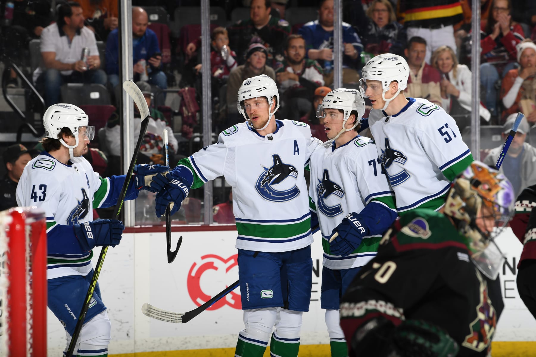 TEMPE, ARIZONA - APRIL 13: Elias Pettersson #40 of the Vancouver Canucks celebrates with Anthony Beauvillier #72, Quinn Hughes #43 and teammates after scoring a goal against the Arizona Coyotes during the first period at Mullett Arena on April 13, 2023 in Tempe, Arizona. (Photo by Norm Hall/NHLI via Getty Images)