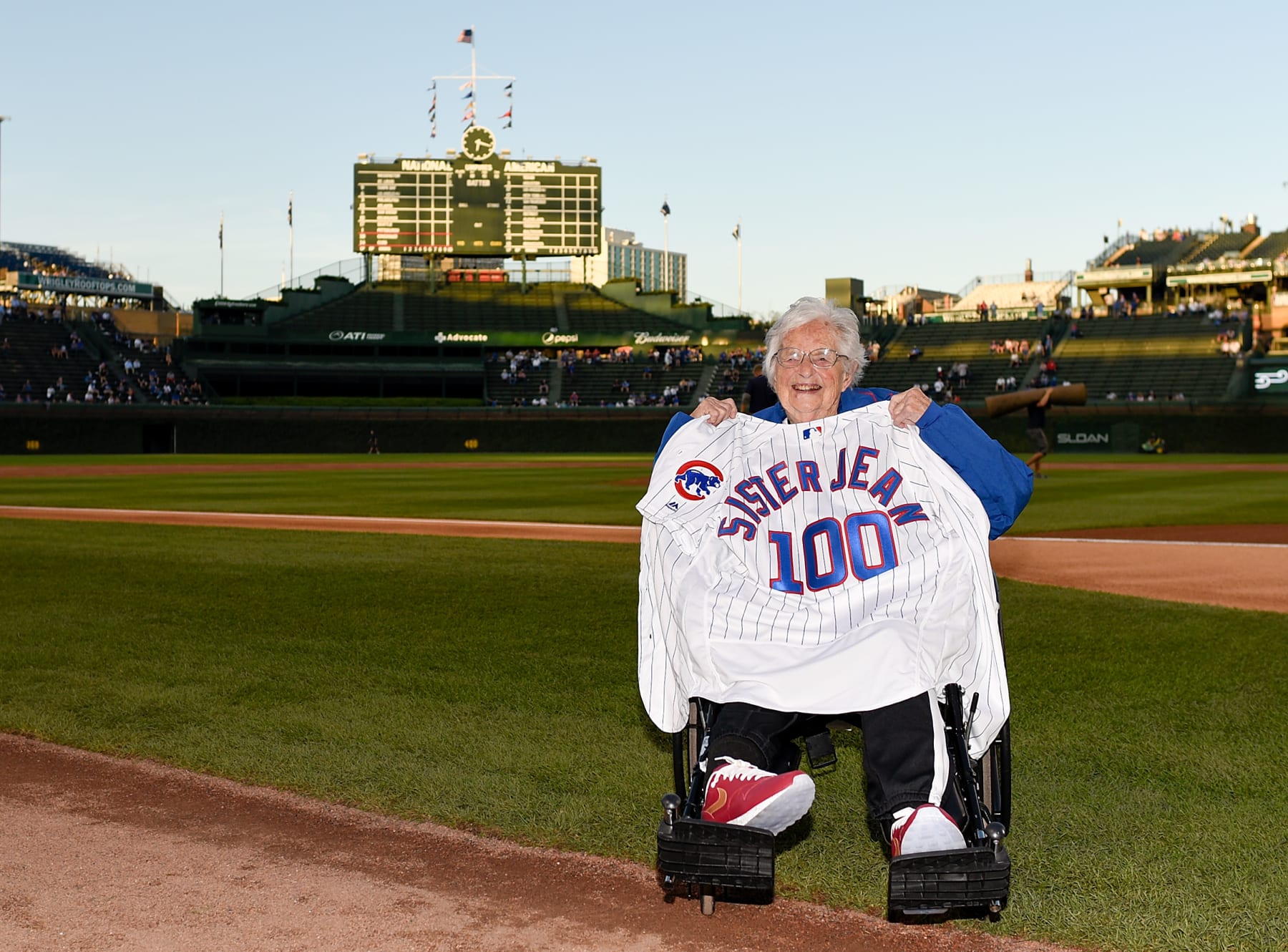 CHICAGO, ILLINOIS - SEPTEMBER 18: Dolores Schmidt "Sister Jean" of the Loyola Ramblers men's basketball team poses with a Cubs jersey given to her by manager Joe Maddon before the game between the Chicago Cubs and the Cincinnati Reds at Wrigley Field on September 18, 2019 in Chicago, Illinois. (Photo by Quinn Harris/Getty Images)