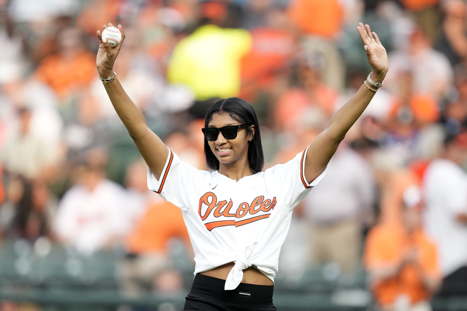 BALTIMORE, MD - JULY 18: LSU basketball star Angel Reese waves to the fans before throwing out the ceremonial first pitch at a baseball game between the Baltimore Orioles and the Los Angeles Dodgers at Oriole Park at Camden Yards on July 18, 2023 in Baltimore, Maryland. (Photo by Mitchell Layton/Getty Images)