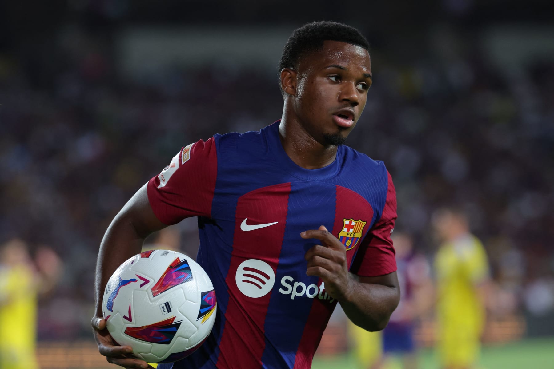 Barcelona's Spanish forward #10 Ansu Fati runs with the ball during the Spanish Liga football match between FC Barcelona and Cadiz CF at the Lluis Companys Olimpic Stadium in Barcelona on August 20, 2023. (Photo by LLUIS GENE / AFP) (Photo by LLUIS GENE/AFP via Getty Images)