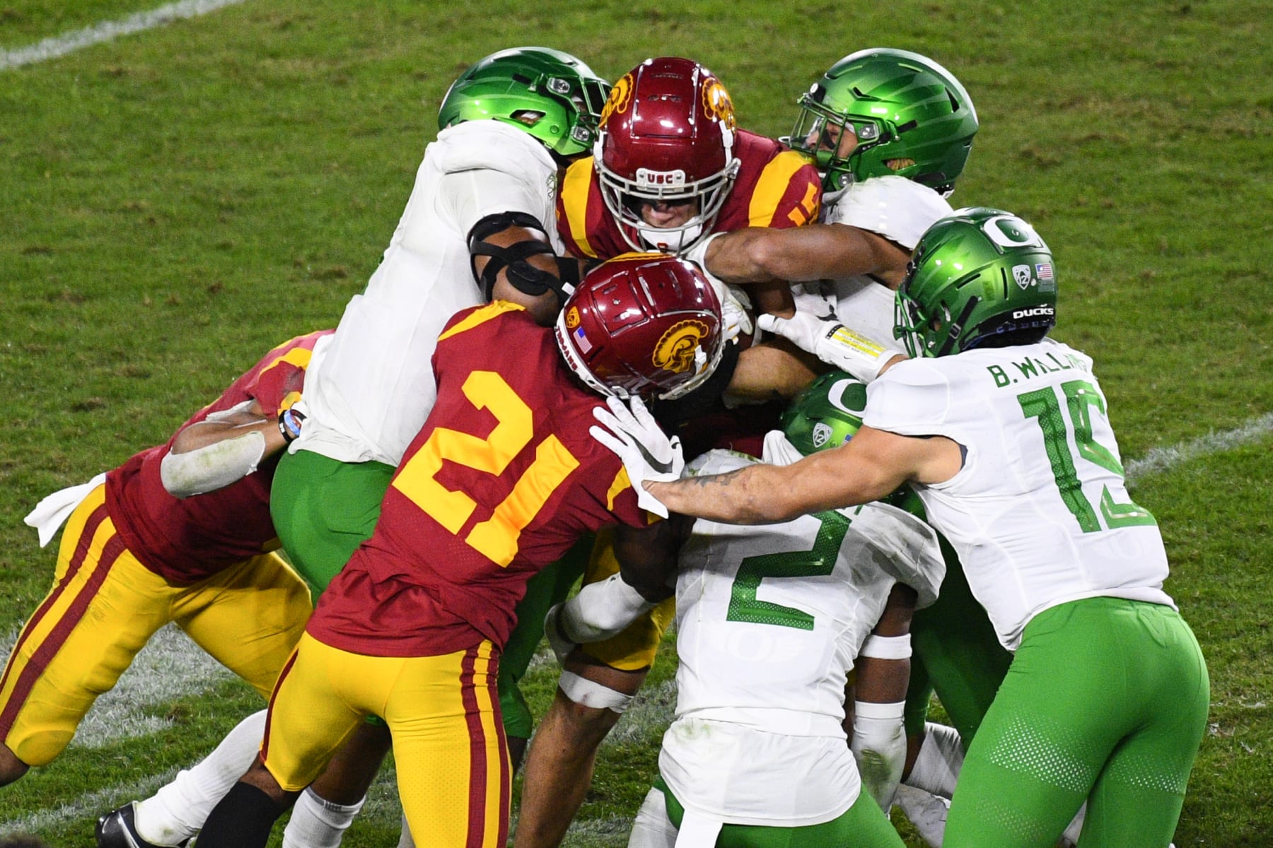 LOS ANGELES, CA - DECEMBER 18: USC Trojans wide receiver Drake London (15) is tackled by several Oregon defenders during the Pac-12 Championship college football game between the Oregon Ducks and the USC Trojans on December 18, 2020, at Los Angeles Memorial Coliseum in Los Angeles, CA. The game was played without fans due to the COVID-19 pandemic. (Photo by Brian Rothmuller/Icon Sportswire via Getty Images)