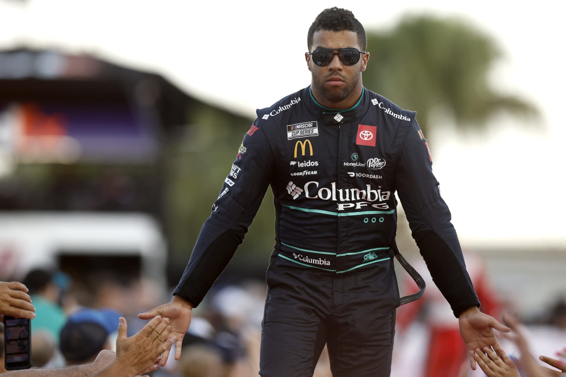 DAYTONA BEACH, FLORIDA - AUGUST 26: Bubba Wallace, driver of the #23 Columbia Sportswear Company Toyota, greets fans as he walks onstage during driver intros prior to the NASCAR Cup Series Coke Zero Sugar 400 at Daytona International Speedway on August 26, 2023 in Daytona Beach, Florida. (Photo by Sean Gardner/Getty Images)