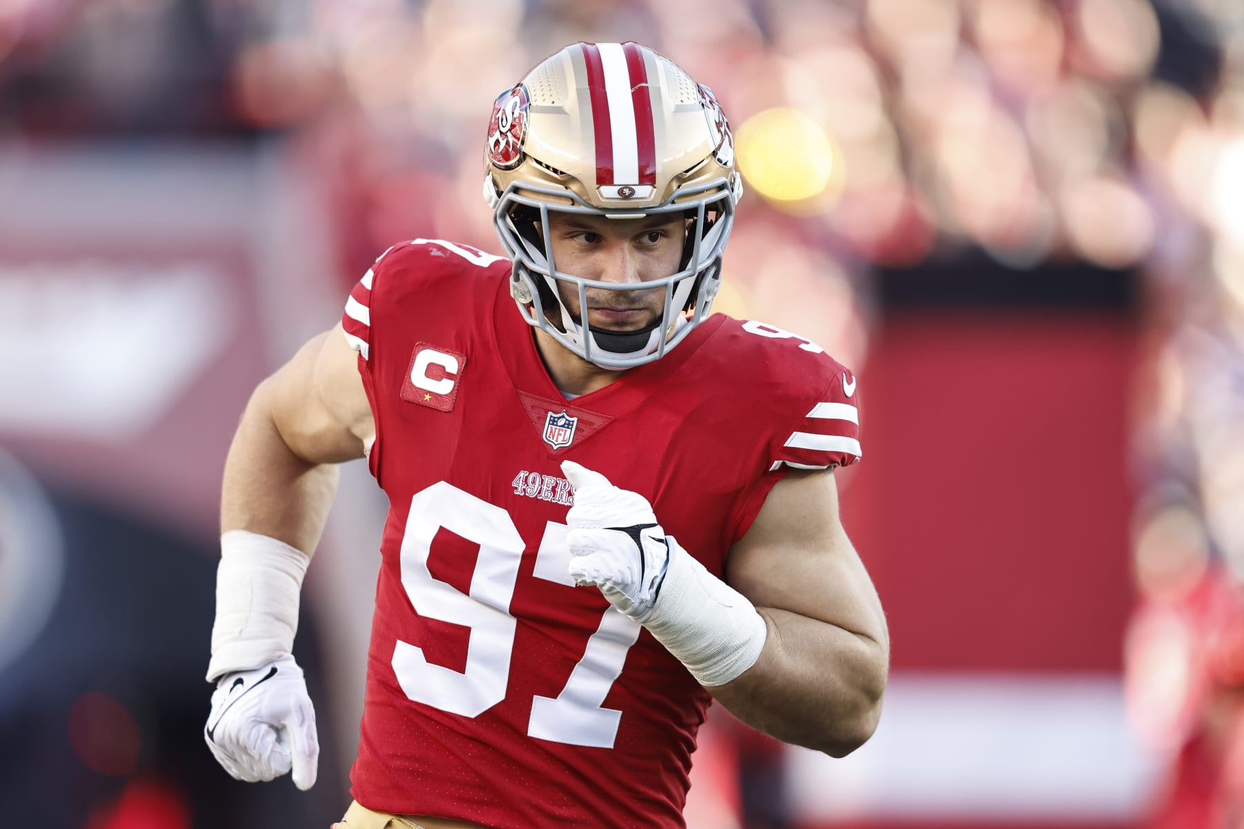 San Francisco 49ers first-round pick Nick Bosa, center, holds up a