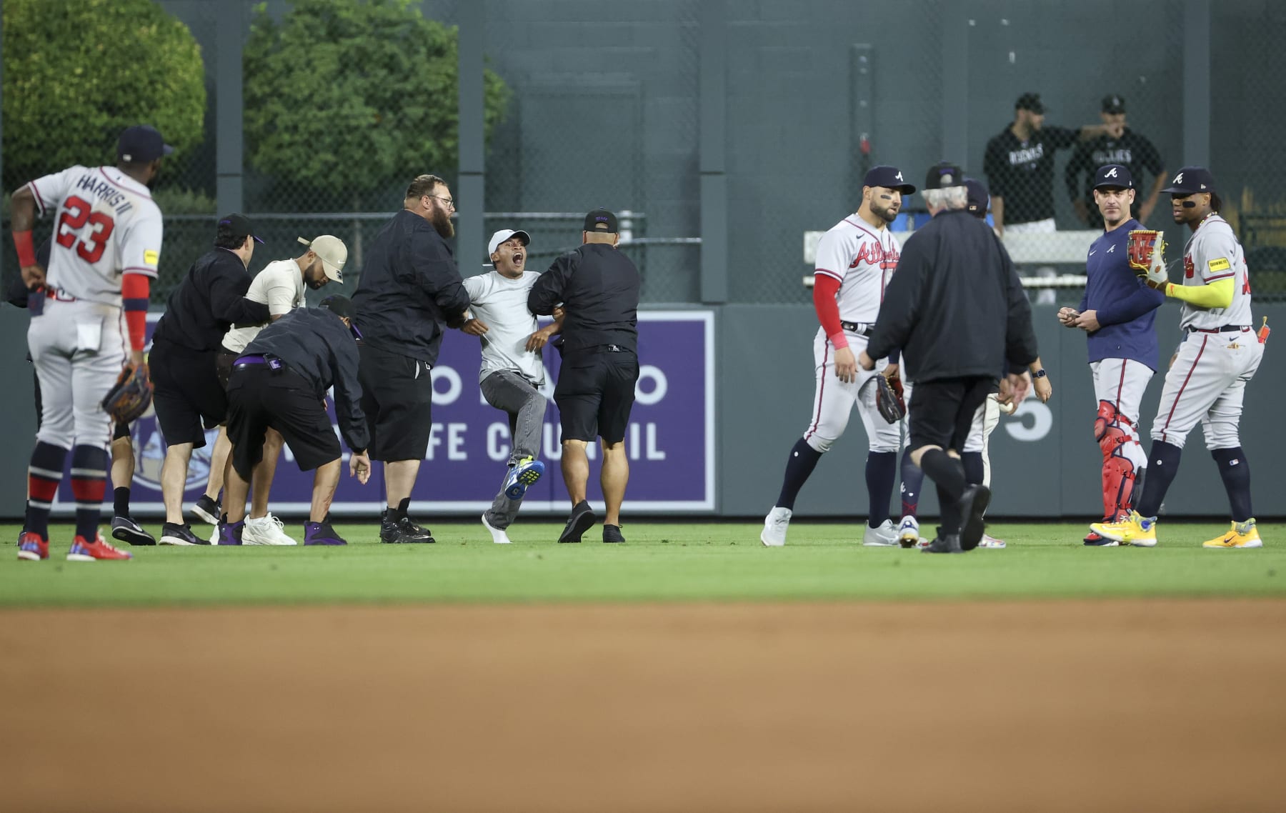 DENVER, COLORADO - AUGUST 28: A fan yells to Ronald Acuna Jr. #13 of the Atlanta Braves after running on the field and being apprehended by security during the game between the Colorado Rockies and the Atlanta Braves at Coors Field on August 28, 2023 in Denver, Colorado. (Photo by Tyler Schank/Clarkson Creative/Getty Images) DENVER, COLORADO - AUGUST 28: A fan yells to Ronald Acuna Jr. #13 of the Atlanta Braves after running on the field and being apprehended by security during the game between the Colorado Rockies and the Atlanta Braves at Coors Field on August 28, 2023 in Denver, Colorado. (Photo by Tyler Schank/Clarkson Creative/Getty Images)
