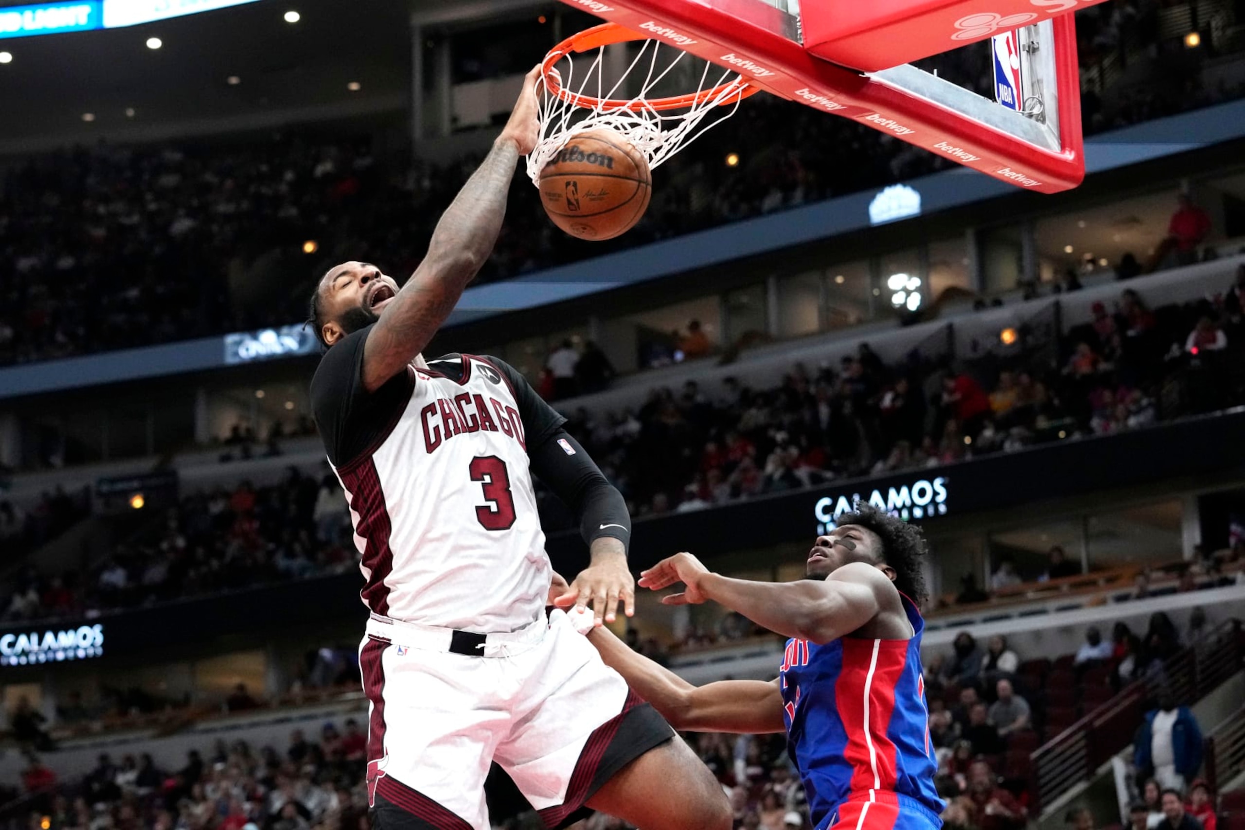 Chicago Bulls center Andre Drummond, left, dunks as Detroit Pistons center James Wiseman looks on during the second half of an NBA basketball game in Chicago, Sunday, April 9, 2023. The Bulls won 103-81. (AP Photo/Nam Y. Huh) Chicago Bulls center Andre Drummond, left, dunks as Detroit Pistons center James Wiseman looks on during the second half of an NBA basketball game in Chicago, Sunday, April 9, 2023. The Bulls won 103-81. (AP Photo/Nam Y. Huh)