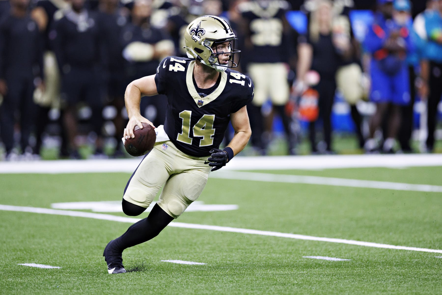 Jake Haener of the New Orleans Saints drops back to pass during