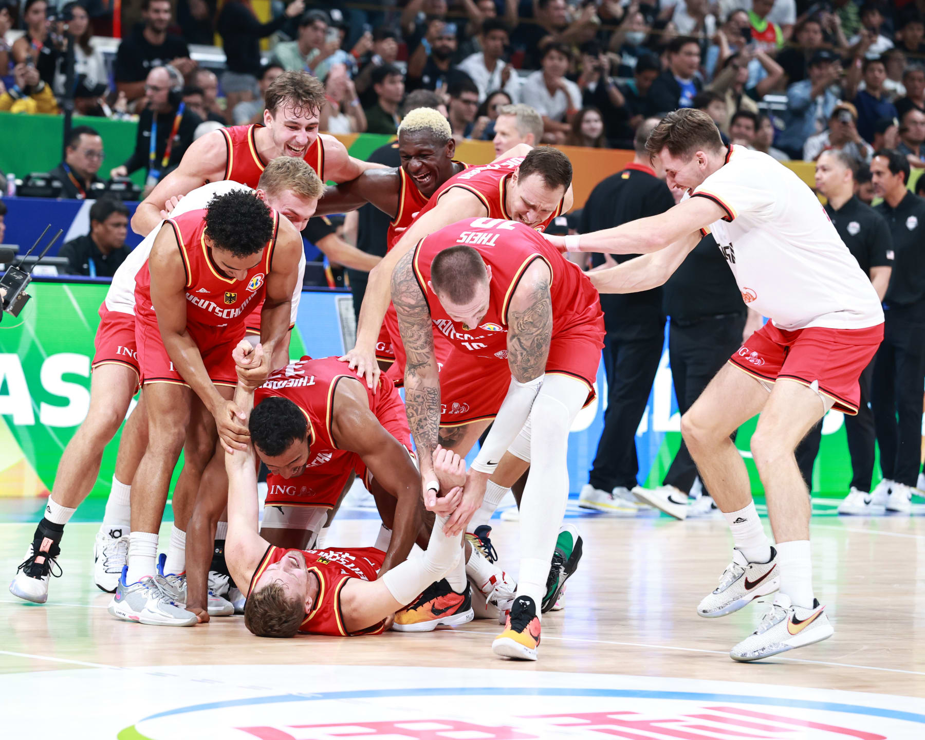 MANILA, PHILIPPINES - SEPTEMBER 8: The German Mens National team celebrates after the game in the semi-finals as part of the 2023 FIBA World Cup on September 8, 2023 at Mall of Asia Arena in Manila, Philippines. NOTE TO USER: User expressly acknowledges and agrees that, by downloading and/or using this photograph, user is consenting to the terms and conditions of the Getty Images License Agreement. Mandatory Copyright Notice: Copyright 2023 NBAE (Photo by Nathaniel S. Butler/NBAE via Getty Images)
