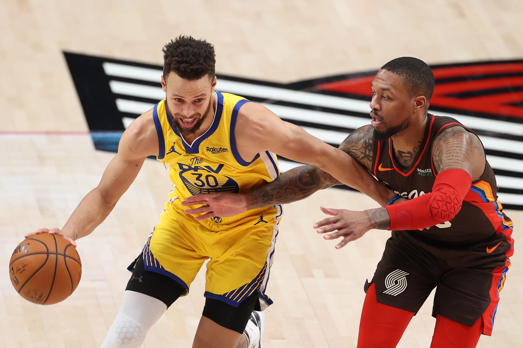 PORTLAND, OREGON - MARCH 03: Stephen Curry #30 of the Golden State Warriors dribbles against Damian Lillard #0 of the Portland Trail Blazers in the first quarter at Moda Center on March 03, 2021 in Portland, Oregon. NOTE TO USER: User expressly acknowledges and agrees that, by downloading and or using this photograph, User is consenting to the terms and conditions of the Getty Images License Agreement. (Photo by Abbie Parr/Getty Images)