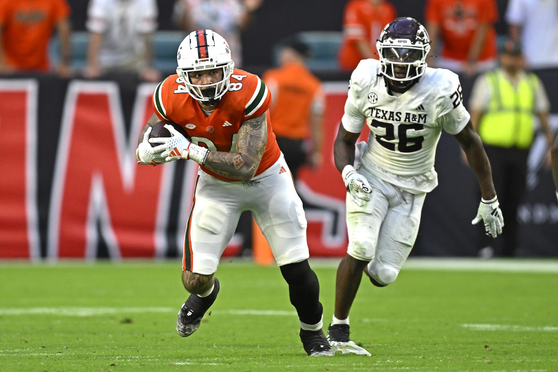 MIAMI GARDENS, FL - SEPTEMBER 09: Miami tight end Cam McCormick (84) takes a reception 20 yards while pursued by Texas A&M defensive back Demani Richardson (26) in the fourth quarter as the Miami Hurricanes faced the Texas A&M Aggies on September 9, 2023, at Hard Rock Stadium in Miami Gardens, Florida. (Photo by Samuel Lewis/Icon Sportswire via Getty Images)
