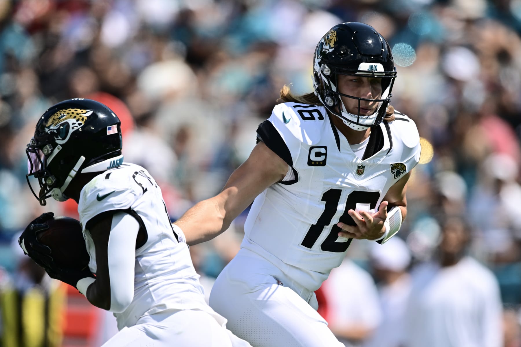 JACKSONVILLE, FLORIDA - SEPTEMBER 24: Trevor Lawrence #16 of the Jacksonville Jaguars hands the ball to Travis Etienne Jr. #1 of the Jacksonville Jaguars during the first quarter of a game against the Houston Texans at EverBank Stadium on September 24, 2023 in Jacksonville, Florida. (Photo by Julio Aguilar/Getty Images)