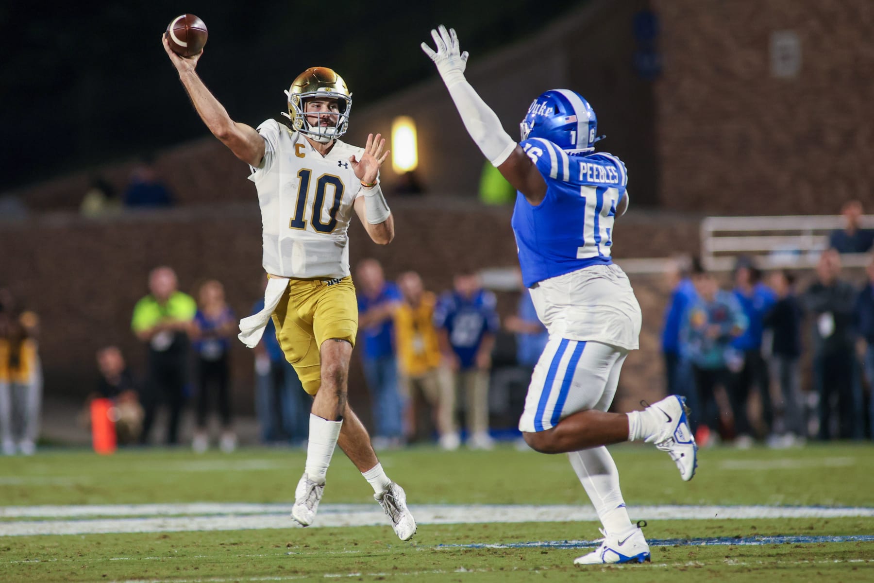 DURHAM, NC - SEPTEMBER 30: Notre Dame Fighting Irish quarterback Sam Hartman (10) throws on the run as Duke Blue Devils defensive tackle Aeneas Peebles (16) gets hands up during the college football between the Duke Blue Devils and the Notre Dame Fighting Irish on September 30, 2023, on Brooks Field at Wallace Wade Stadium in Durham, NC. (Photo by Nicholas Faulkner/Icon Sportswire via Getty Images)