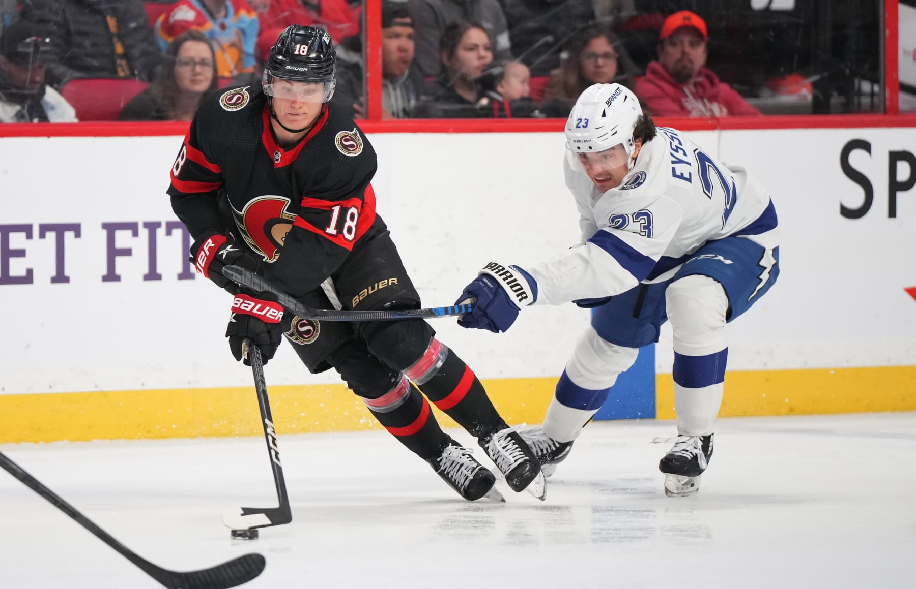 OTTAWA, CANADA - APRIL 8: Tim Stützle #18 of the Ottawa Senators is slashed by Michael Eyssimont #23 of the Tampa Bay Lightning at Canadian Tire Centre on April 8, 2023 in Ottawa, Ontario, Canada. (Photo by André Ringuette/NHLI via Getty Images)
