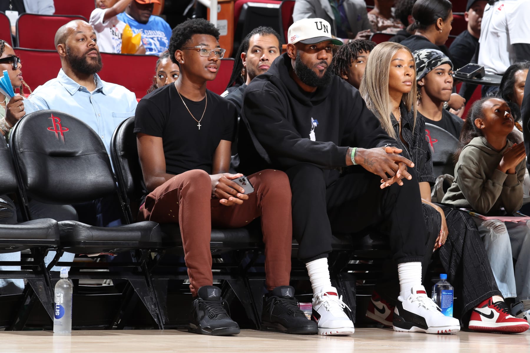 HOUSTON, TX - MARCH 28: From left to right  Bryce James and LeBron James and Savannah James are sitting in the front row to watch McDonalds High School All American Bronny James play during the 2023 McDonalds High School All American Boys Game at Toyota Center. (Photo by Brian Spurlock/Icon Sportswire via Getty Images