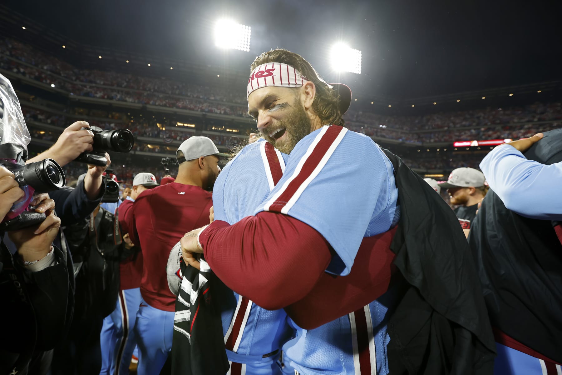 PHILADELPHIA, PENNSYLVANIA - OCTOBER 12: Brandon Marsh #16 and Bryce Harper #3 of the Philadelphia Phillies celebrate after beating the Atlanta Braves 3-1 in Game Four of the Division Series at Citizens Bank Park on October 12, 2023 in Philadelphia, Pennsylvania. (Photo by Rich Schultz/Getty Images)