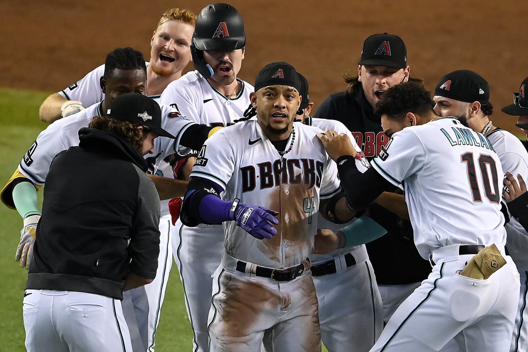 PHOENIX, ARIZONA - OCTOBER 19: Ketel Marte #4 of the Arizona Diamondbacks celebrates with his teammates after hitting an RBI single against Craig Kimbrel #31 of the Philadelphia Phillies to win Game Three of the National League Championship Series at Chase Field on October 19, 2023 in Phoenix, Arizona. (Photo by Norm Hall/Getty Images)