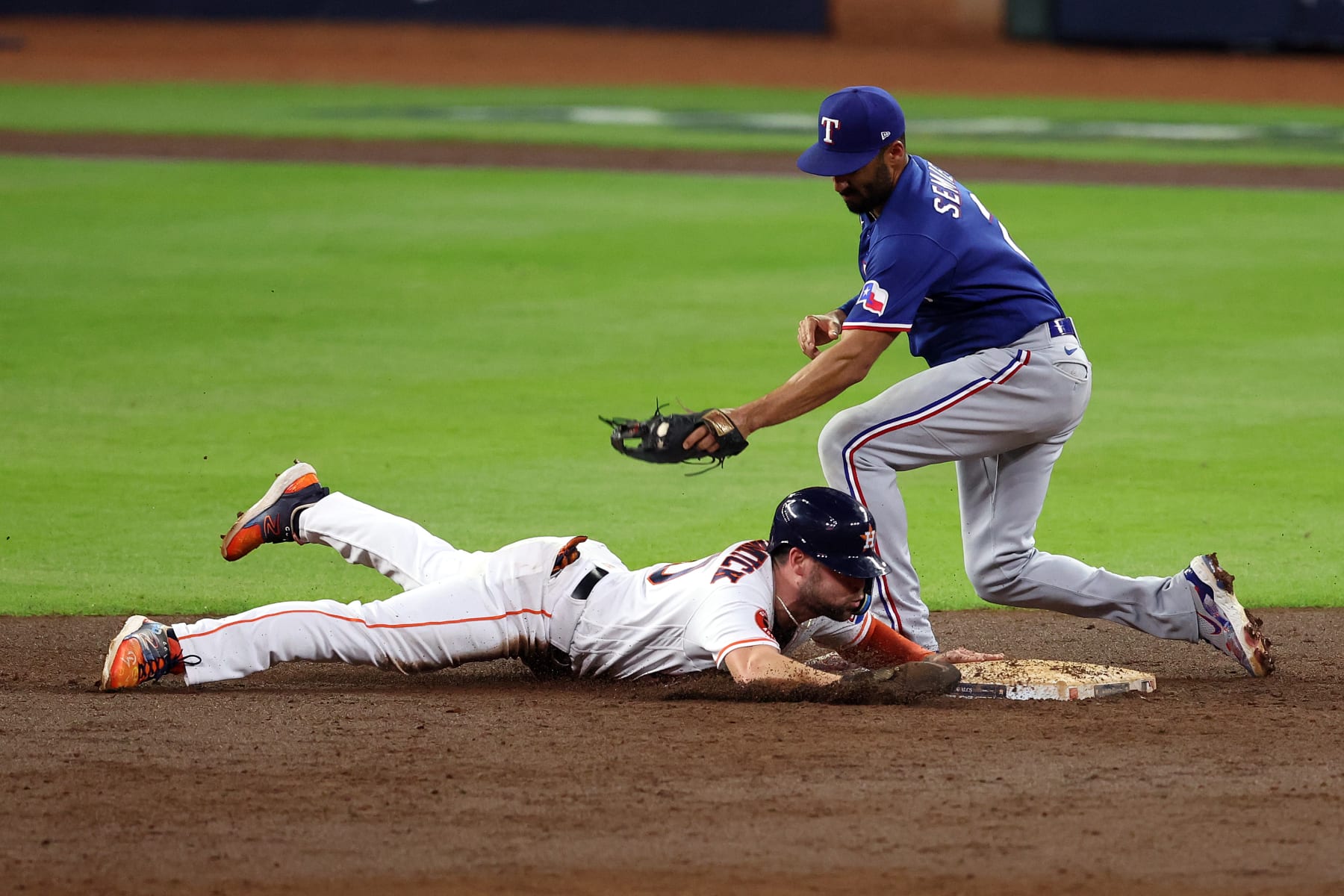 HOUSTON, TEXAS - OCTOBER 23: Chas McCormick #20 of the Houston Astros steals second base against Marcus Semien #2 of the Texas Rangers during the second inning in Game Seven of the American League Championship Series at Minute Maid Park on October 23, 2023 in Houston, Texas. (Photo by Rob Carr/Getty Images)
