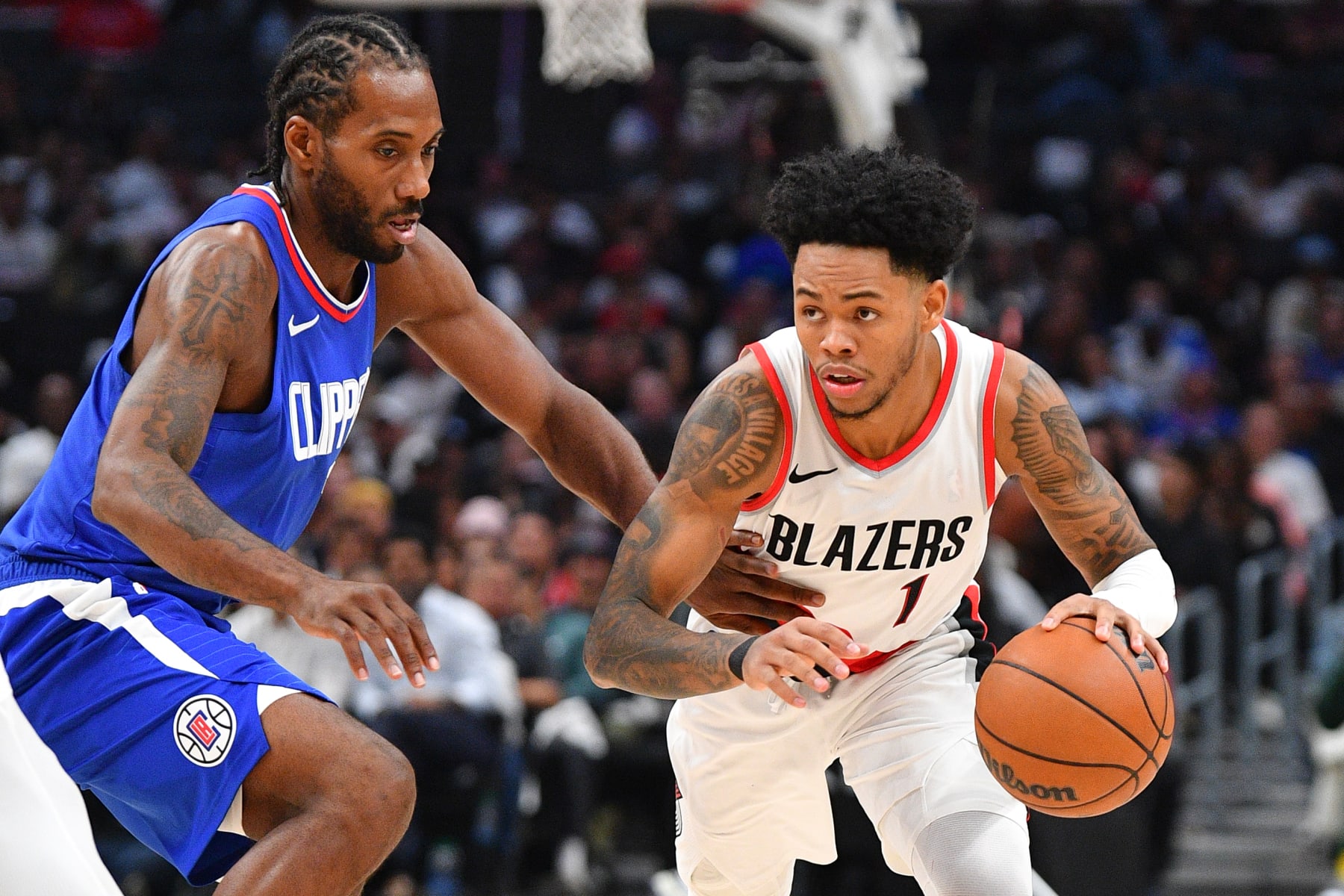 LOS ANGELES, CA - OCTOBER 25: Los Angeles Clippers forward Kawhi Leonard (2) closely guards Portland Trail Blazers guard Anfernee Simons (1) during a NBA  game between the Denver Nuggets and the Portland Trail Blazers on October 25, 2023 at Crypto.com Arena in Los Angeles, CA. (Photo by Brian Rothmuller/Icon Sportswire via Getty Images)