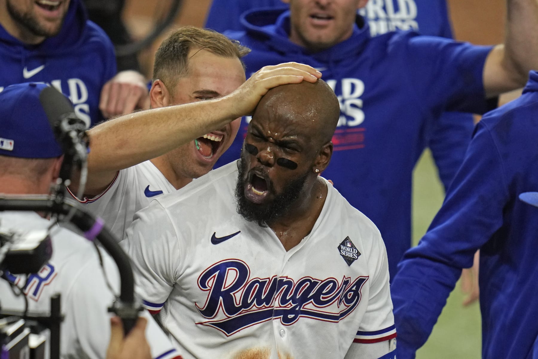 Texas Rangers' Adolis Garcia celebrates with teammates after hitting a game-winning home run during the 11th inning in Game 1 of the baseball World Series Friday, Oct. 27, 2023, in Arlington, Texas. (AP Photo/Julio Cortez)