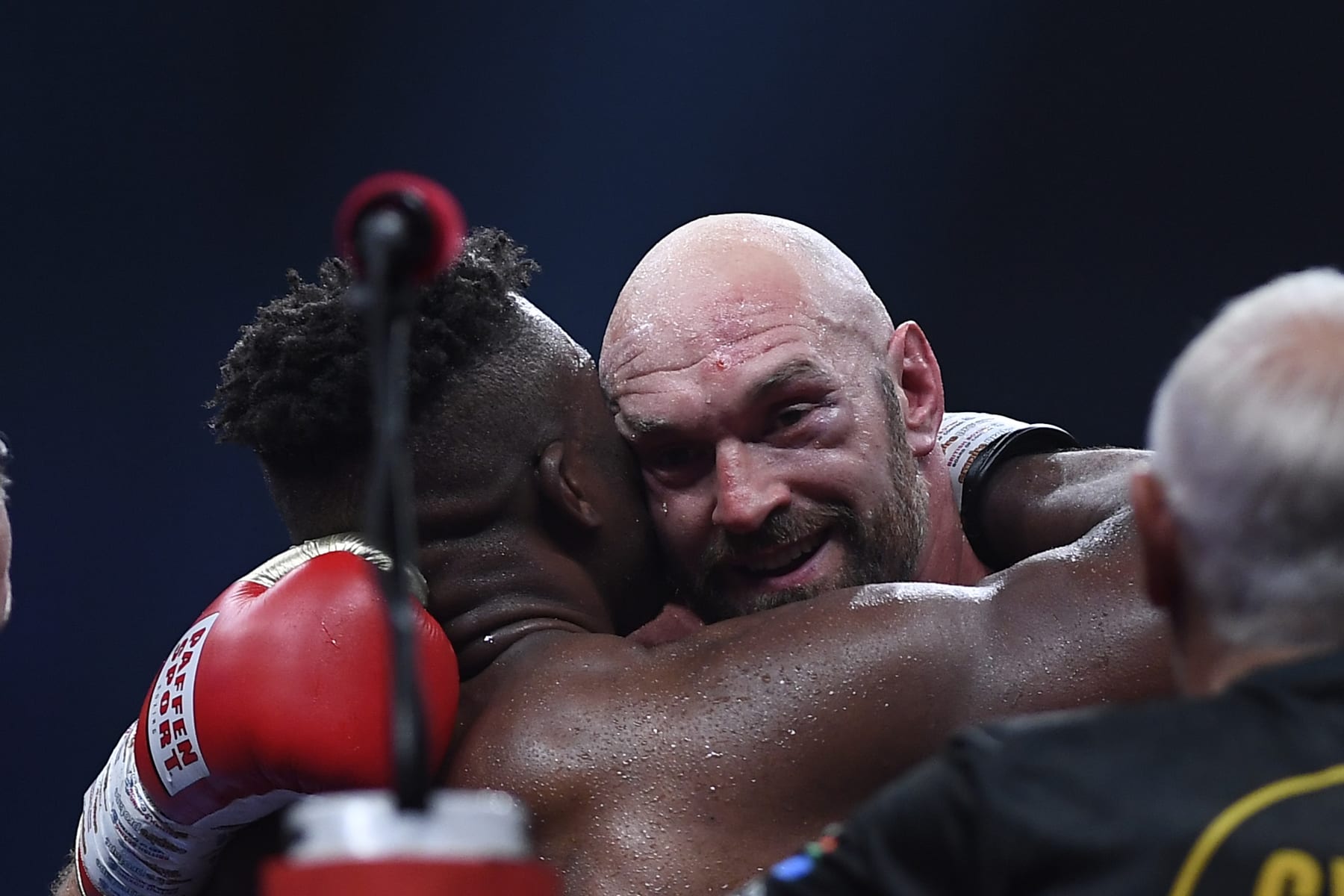 Tyson Fury, of England, the WBC and lineal heavyweight champion, facing, hugs former UFC heavyweight champion Francis Ngannou, of Cameroon, at their boxing match to mark the start of Riyadh Season at Kingdom Arena stadium in Riyadh, Saudi Arabia, Sunday, Oct. 29, 2023. (AP Photo/Yazeed Aldhawaihi)