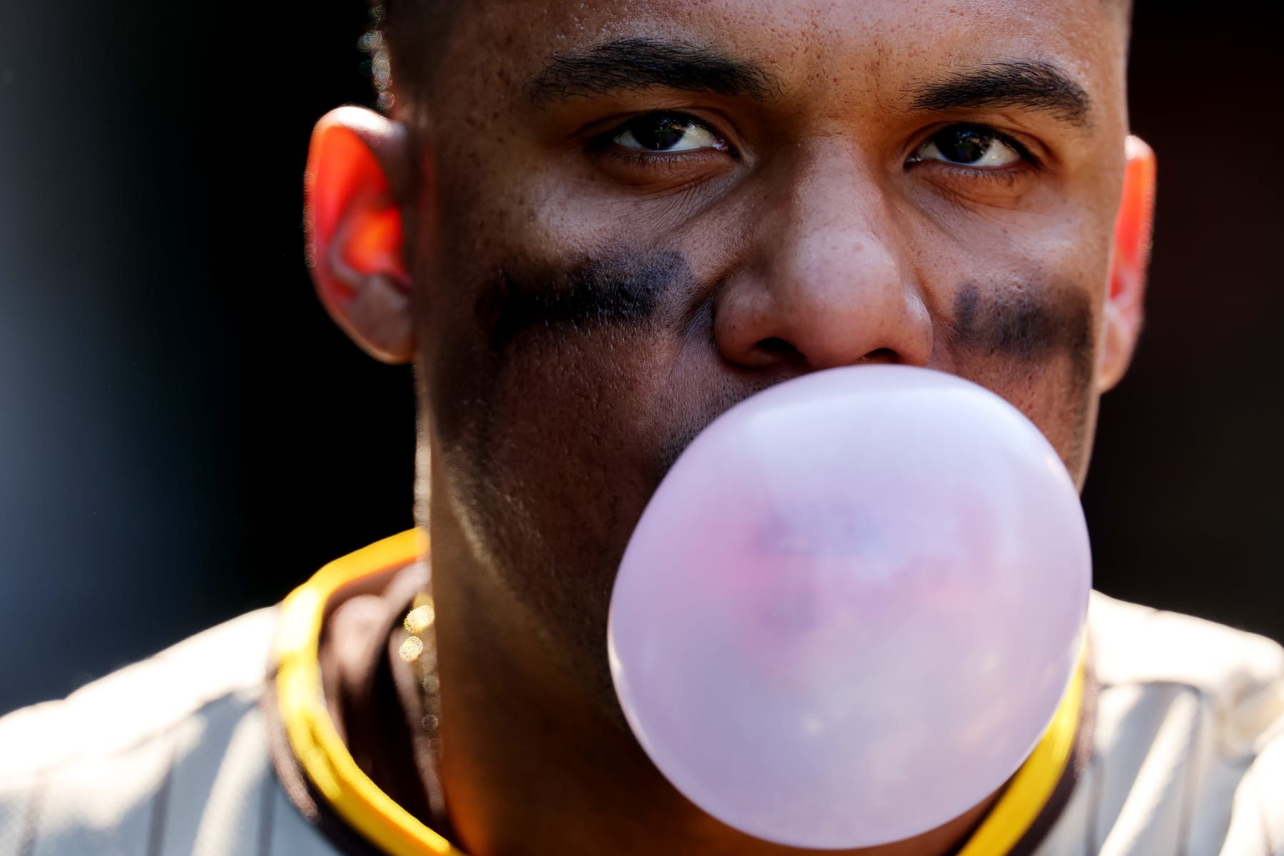CHICAGO, ILLINOIS - APRIL 27: Juan Soto #22 of the San Diego Padres blows a bubble against the Chicago Cubs during the seventh inning at Wrigley Field on April 27, 2023 in Chicago, Illinois. (Photo by Michael Reaves/Getty Images)