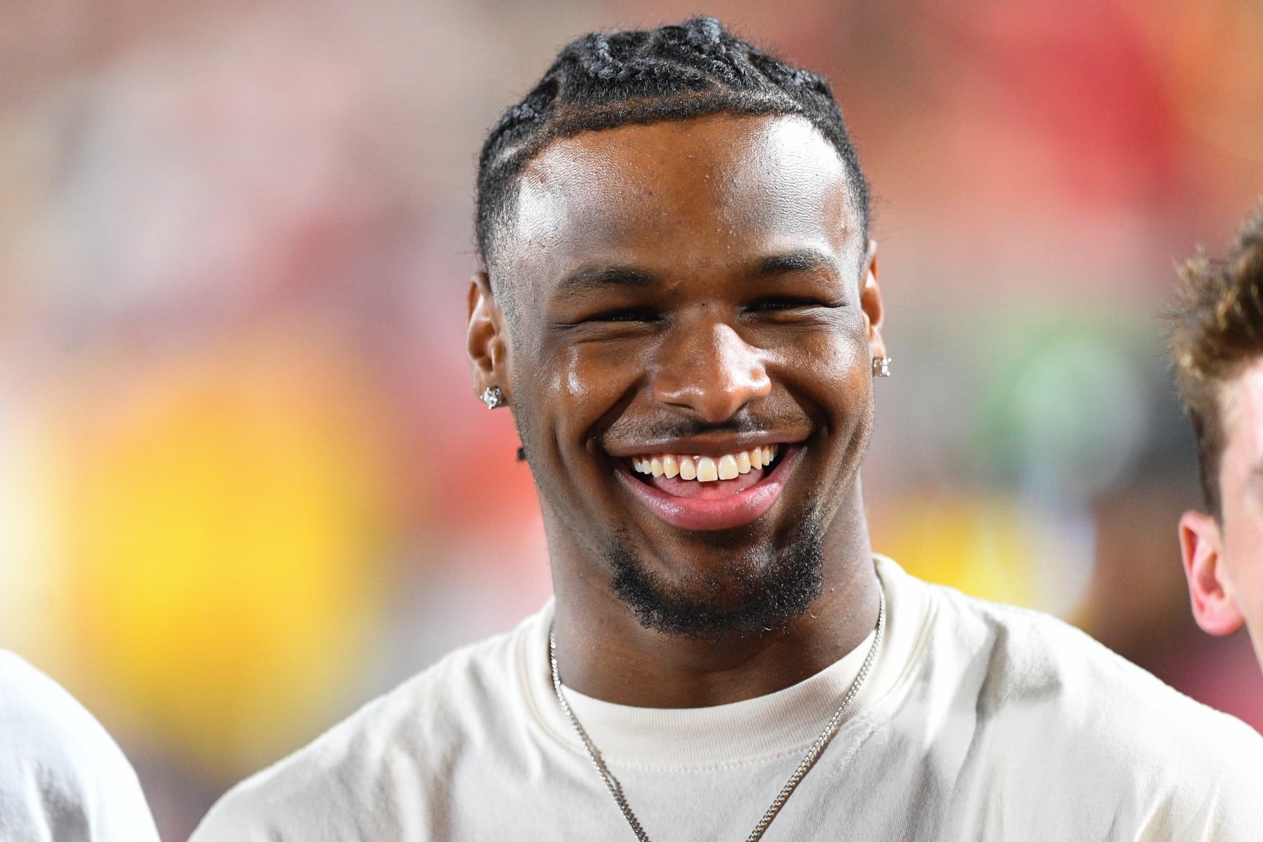 LOS ANGELES, CA - AUGUST 26: USC basketball player Bronny James jokes around on the sidelines during a game between the San Jose State Spartans and the USC Trojans on August 26, 2023, at Los Angeles Memorial Coliseum in Los Angeles, CA. (Photo by Brian Rothmuller/Icon Sportswire via Getty Images)