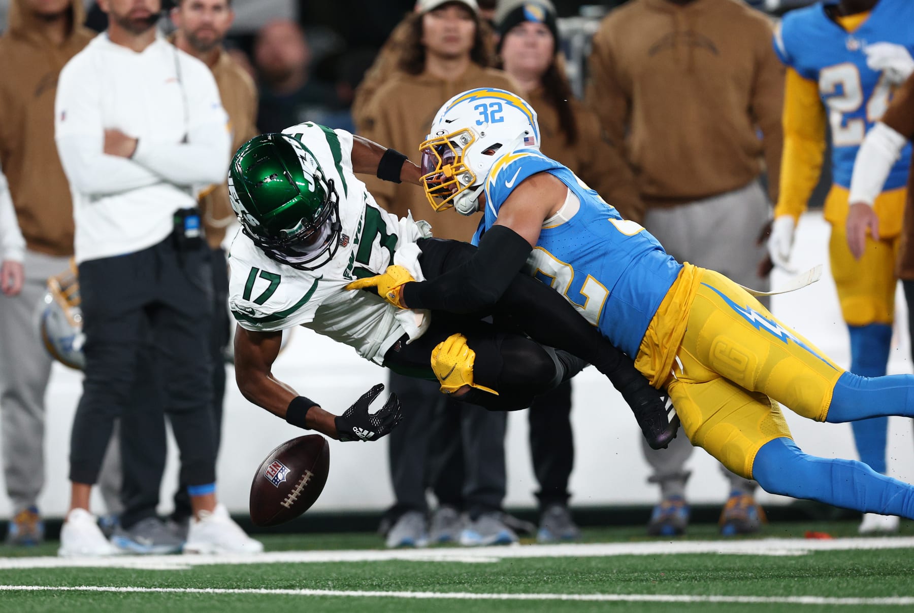 EAST RUTHERFORD, NEW JERSEY - NOVEMBER 06: Garrett Wilson #17 of the New York Jets fumbles the ball as he is tackled by Alohi Gilman #32 of the Los Angeles Chargers during the first quarter at MetLife Stadium on November 06, 2023 in East Rutherford, New Jersey. (Photo by Elsa/Getty Images)