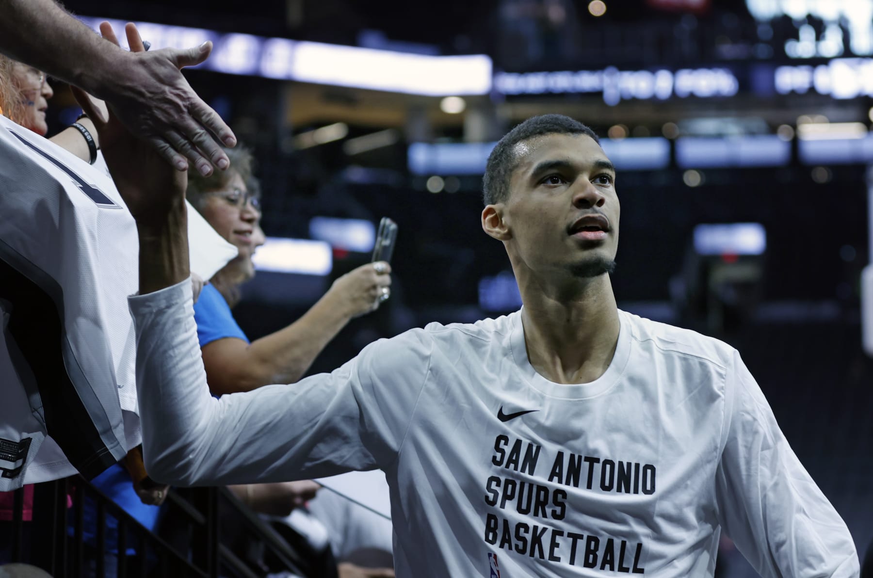 SAN ANTONIO, TX - NOVEMBER 5:  Victor Wembanyama #1 of the San Antonio Spurs greets fans before their game against the Toronto Raptors at Frost Bank Center on November  5, 2023 in San Antonio, Texas. NOTE TO USER: User expressly acknowledges and agrees that, by downloading and or using this photograph, User is consenting to terms and conditions of the Getty Images License Agreement. (Photo by Ronald Cortes/Getty Images)