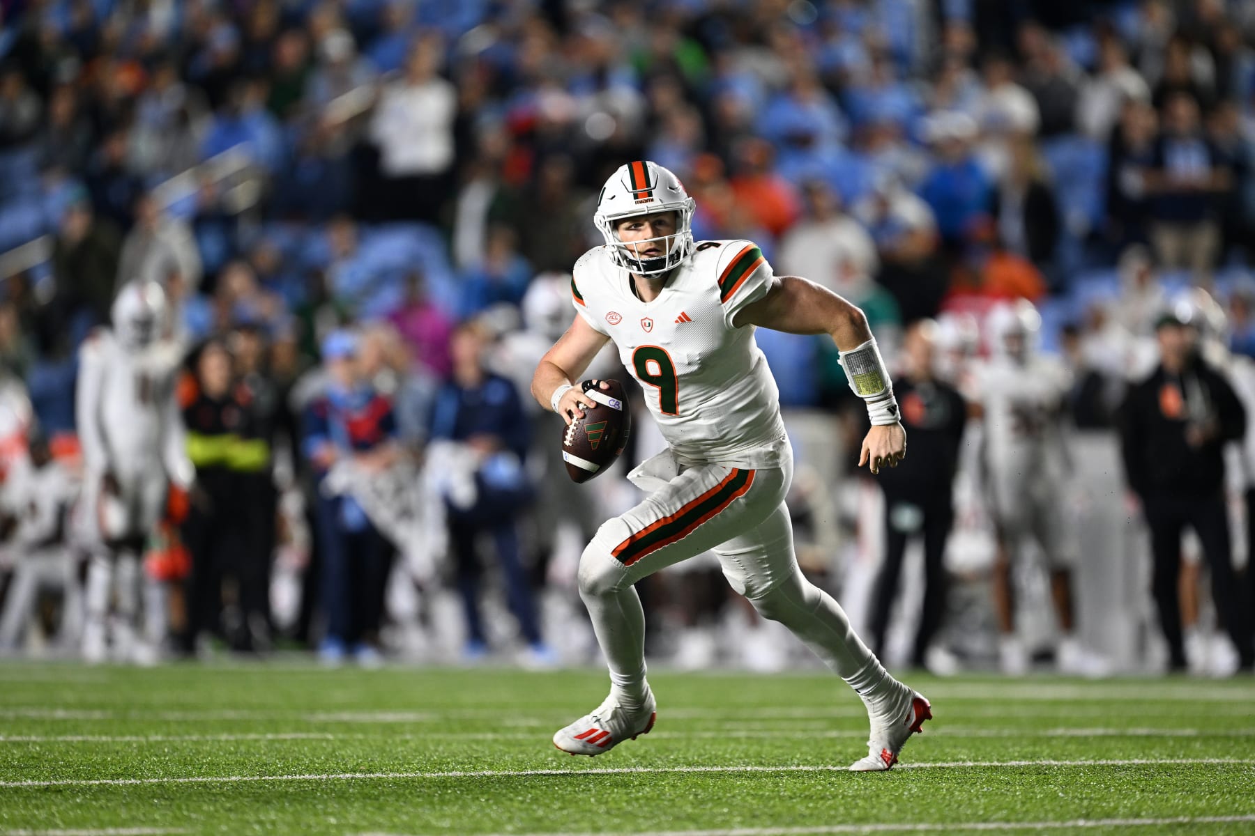 CHAPEL HILL, NORTH CAROLINA - OCTOBER 14: Tyler Van Dyke #9 of the Miami Hurricanes rolls out against the North Carolina Tar Heels during their game at Kenan Memorial Stadium on October 14, 2023 in Chapel Hill, North Carolina. The Tar Heels won 41-31. (Photo by Grant Halverson/Getty Images)