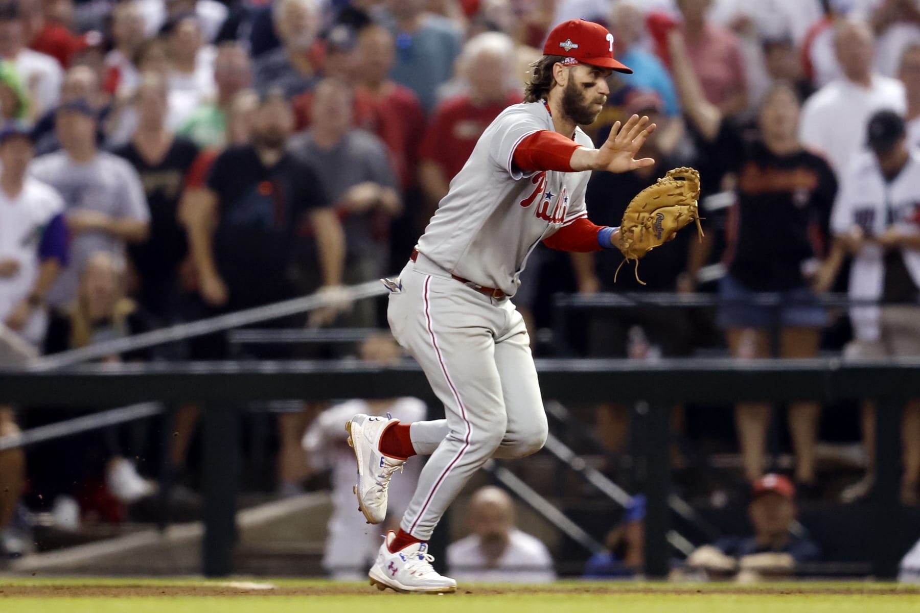 PHOENIX, AZ - OCTOBER 20:  Bryce Harper #3 of the Philadelphia Phillies fields a ground ball during Game 4 of the NLCS between the Philadelphia Phillies and the Arizona Diamondbacks at Chase Field on Friday, October 20, 2023 in Phoenix, Arizona. (Photo by Chris Coduto/MLB Photos via Getty Images)