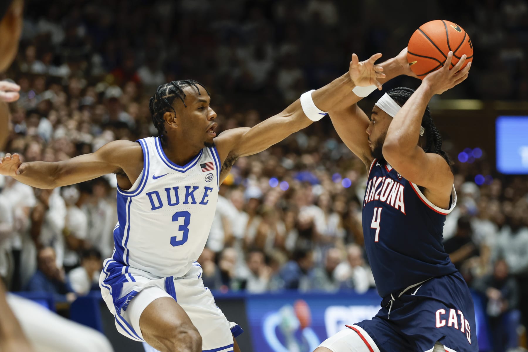 Arizona guard Kylan Boswell (4) looks to pass against Duke guard Jeremy Roach (3) during the first half of an NCAA college basketball game in Durham, N.C., Friday, Nov. 10, 2023. (AP Photo/Nell Redmond)