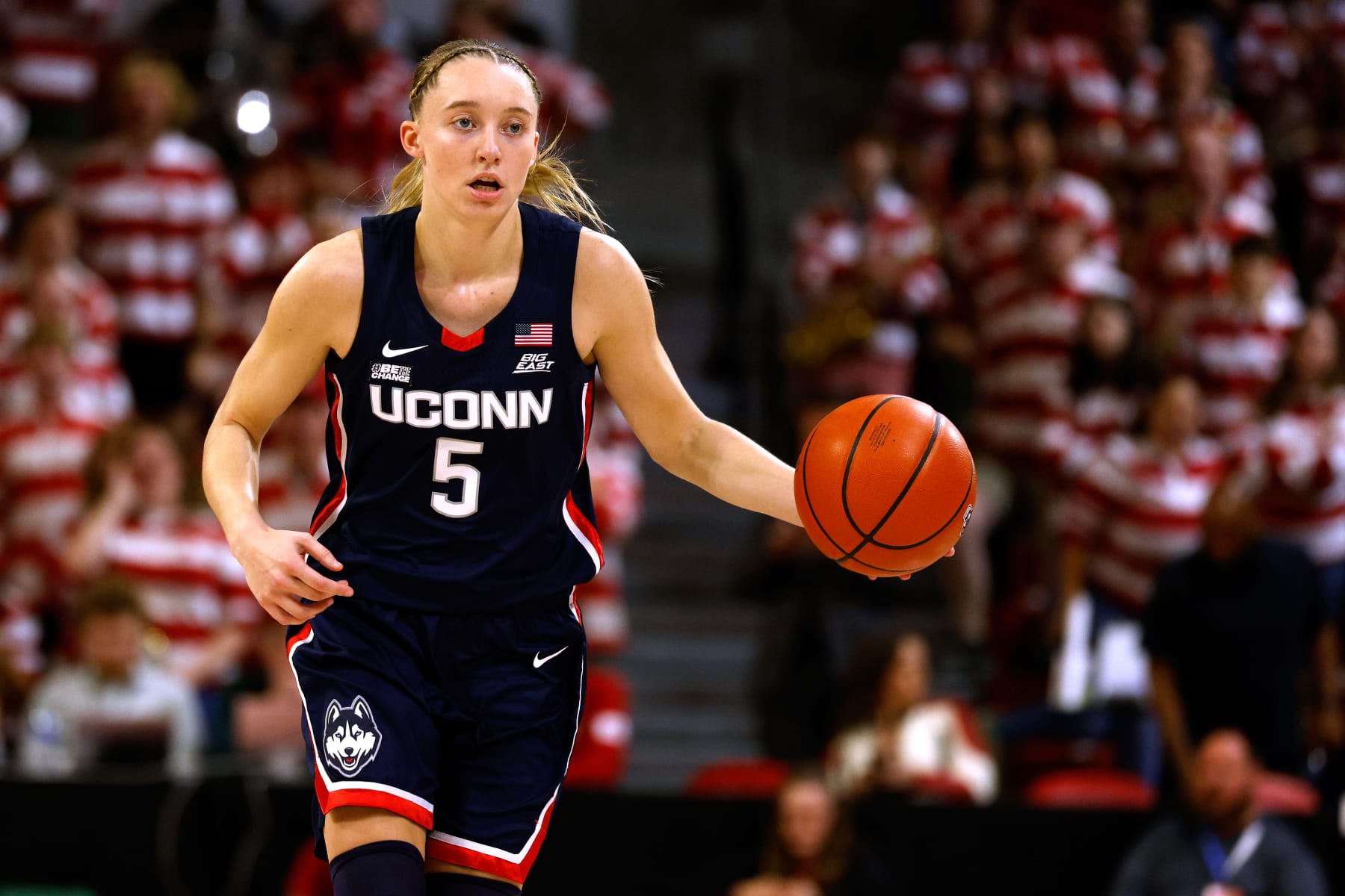 RALEIGH, NORTH CAROLINA - NOVEMBER 12: Paige Bueckers #5 of the UConn Huskies dribbles up court against the NC State Wolfpack during the first half of the game at Reynolds Coliseum on November 12, 2023 in Raleigh, North Carolina. (Photo by Lance King/Getty Images)