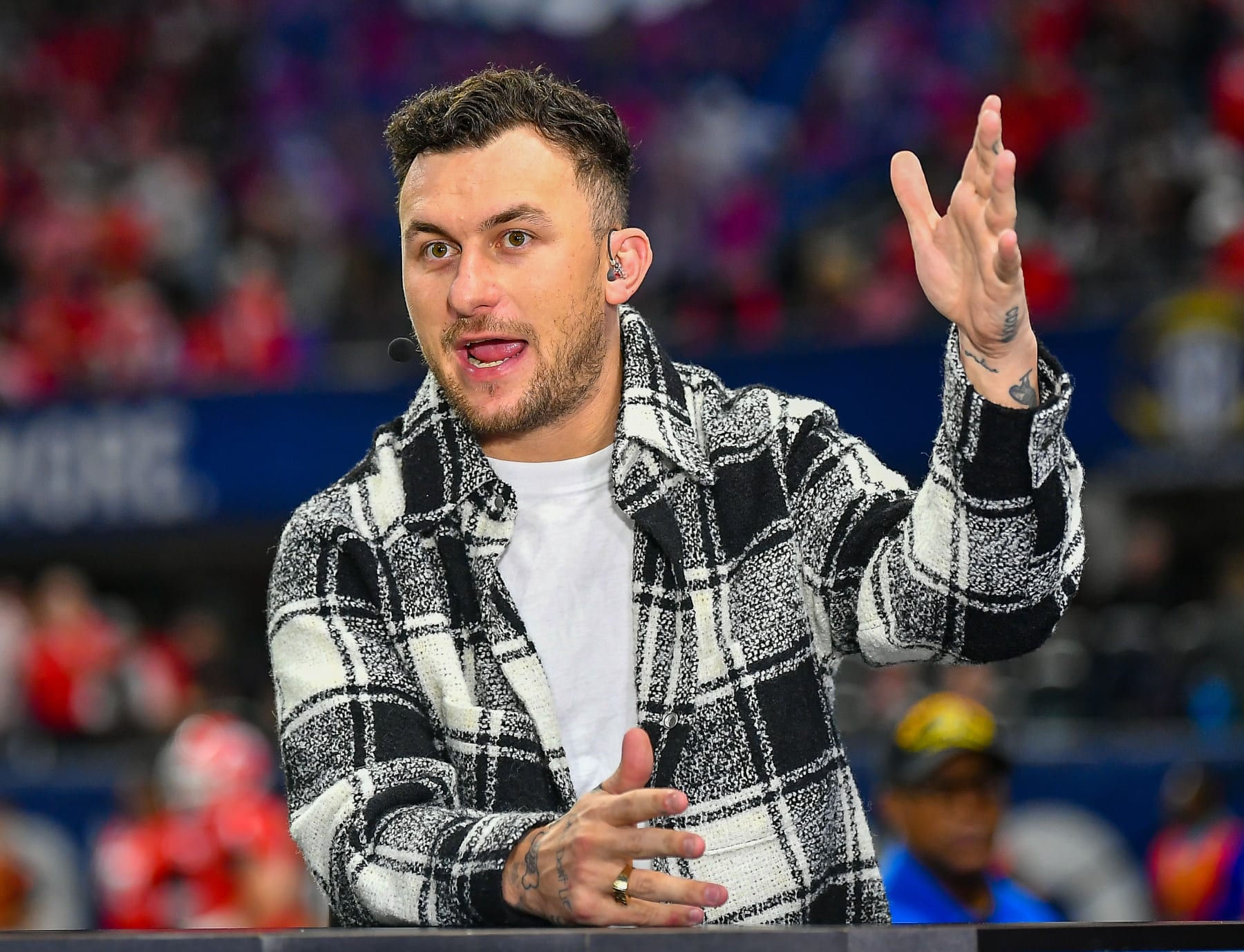 ATLANTA, GA - DECEMBER 03:  Former Texas A&M quarterback Johnny Manziel is interviewed prior to the start of the SEC Championship football game between the LSU Tigers and the Georgia Bulldogs on December 3rd, 2022 at Mercedes-Benz Stadium in Atlanta, GA. (Photo by Rich von Biberstein/Icon Sportswire via Getty Images)