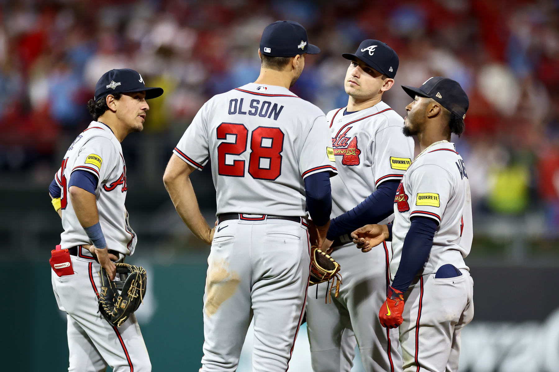 PHILADELPHIA, PENNSYLVANIA - OCTOBER 12: Nicky Lopez #15, Matt Olson #28, Austin Riley #27, and Ozzie Albies #1 of the Atlanta Braves meet in the seventh inning against the Philadelphia Phillies during Game Four of the Division Series at Citizens Bank Park on October 12, 2023 in Philadelphia, Pennsylvania. (Photo by Tim Nwachukwu/Getty Images)