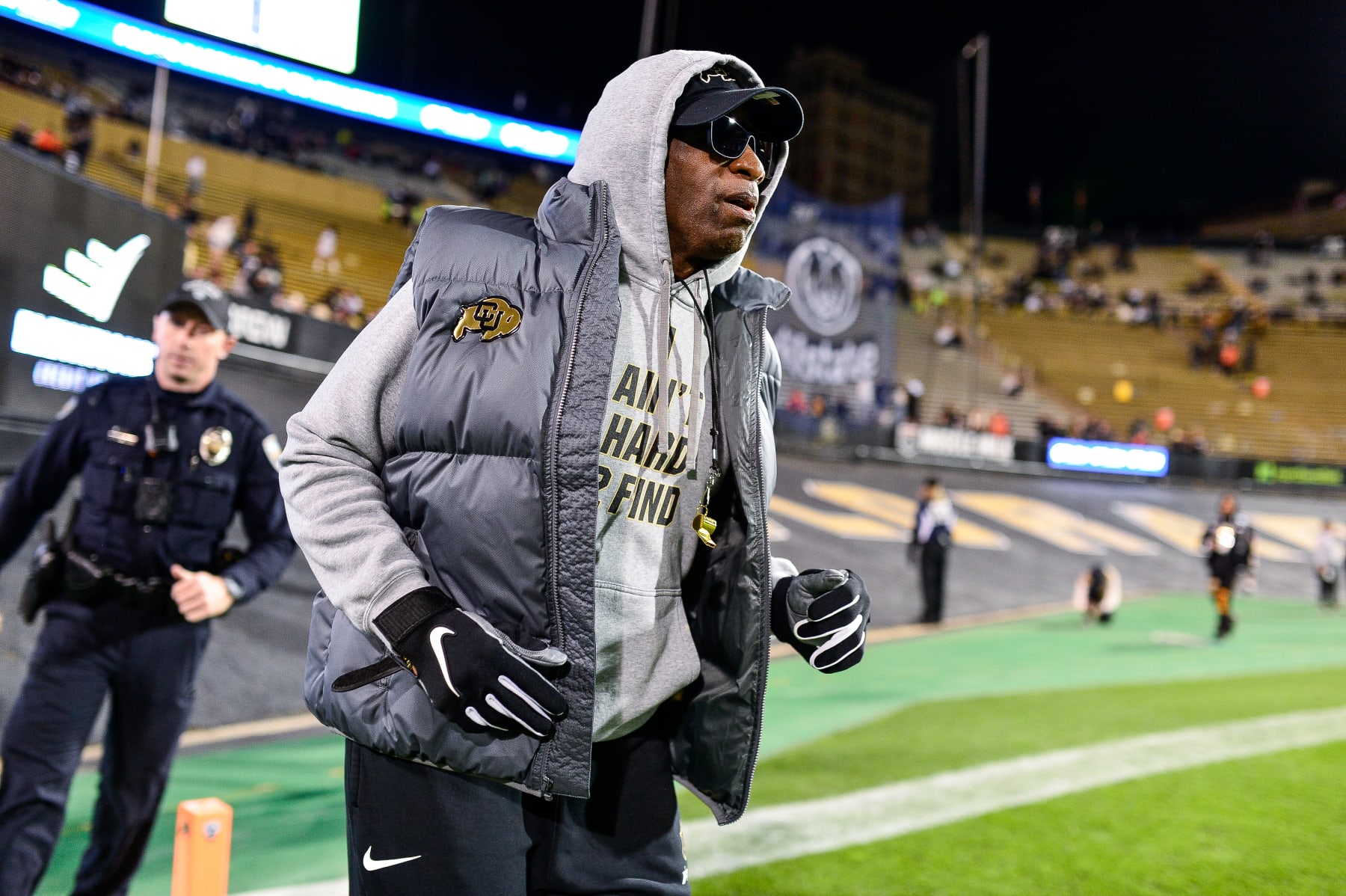 BOULDER, CO - NOVEMBER 4:  Head coach Deion Sanders of the Colorado Buffaloes jogs around the field before a game between the Colorado Buffaloes and the Oregon State Beavers at Folsom Field on November 4, 2023 in Boulder, Colorado. (Photo by Dustin Bradford/Getty Images)