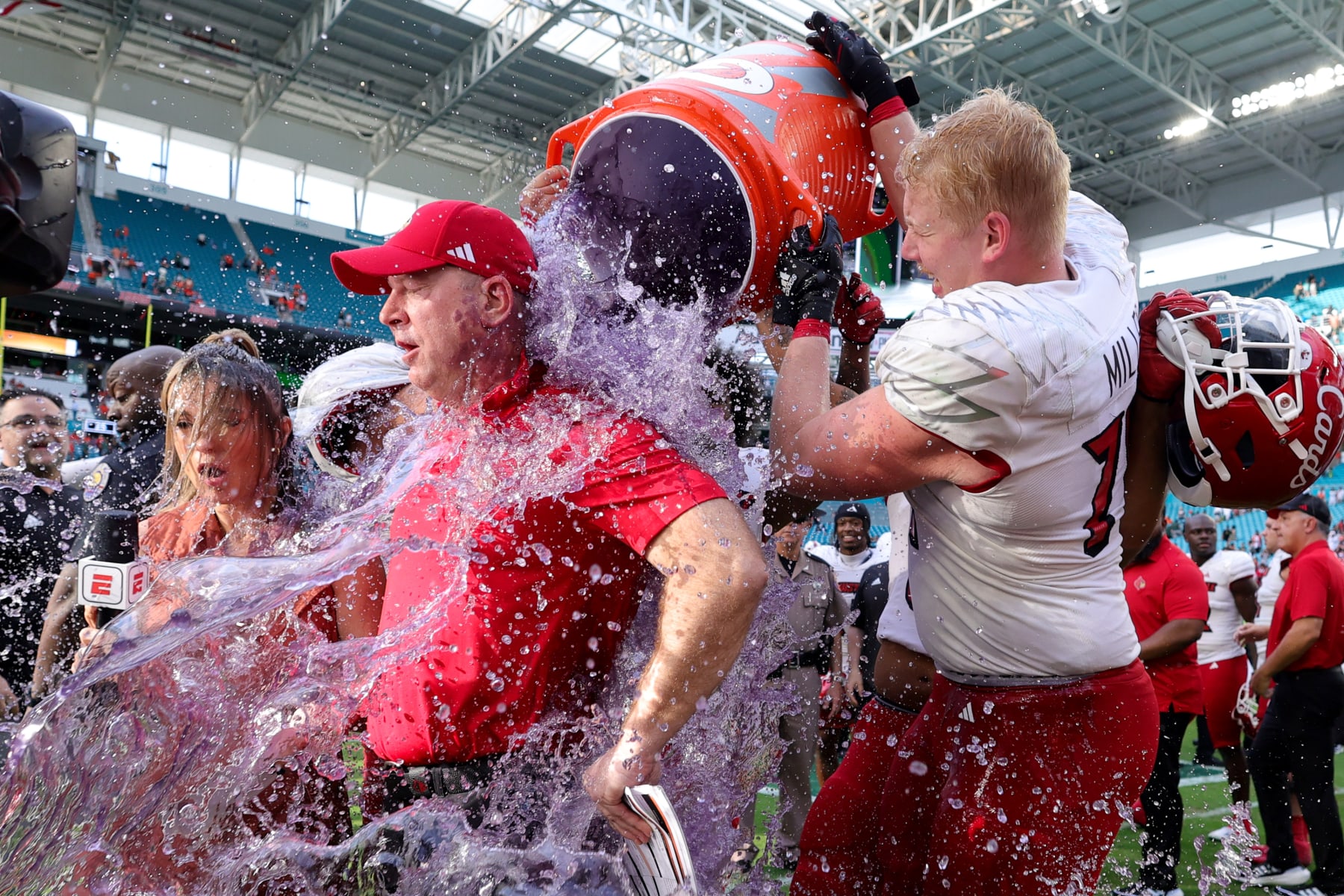 MIAMI GARDENS, FLORIDA - NOVEMBER 18: Head coach Jeff Brohm of the Louisville Cardinals receives a a gatorade bath after defeating the Miami Hurricanes at Hard Rock Stadium on November 18, 2023 in Miami Gardens, Florida. (Photo by Megan Briggs/Getty Images)