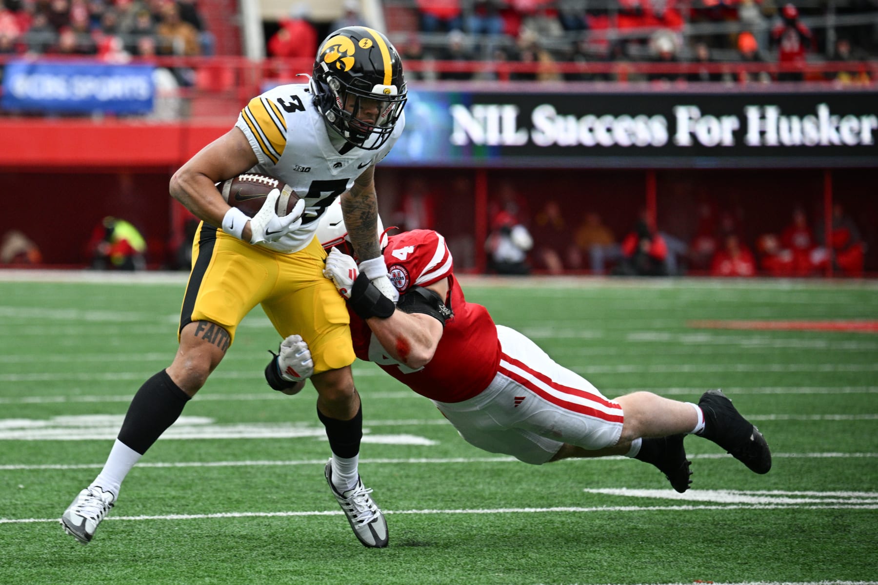 LINCOLN, NEBRASKA - NOVEMBER 24: Wide receiver Kaleb Brown #3 of the Iowa Hawkeyes escapes the tackle of linebacker Luke Reimer #4 of the Nebraska Cornhuskers in the second quarter at Memorial Stadium on November 24, 2023 in Lincoln, Nebraska. (Photo by Steven Branscombe/Getty Images)