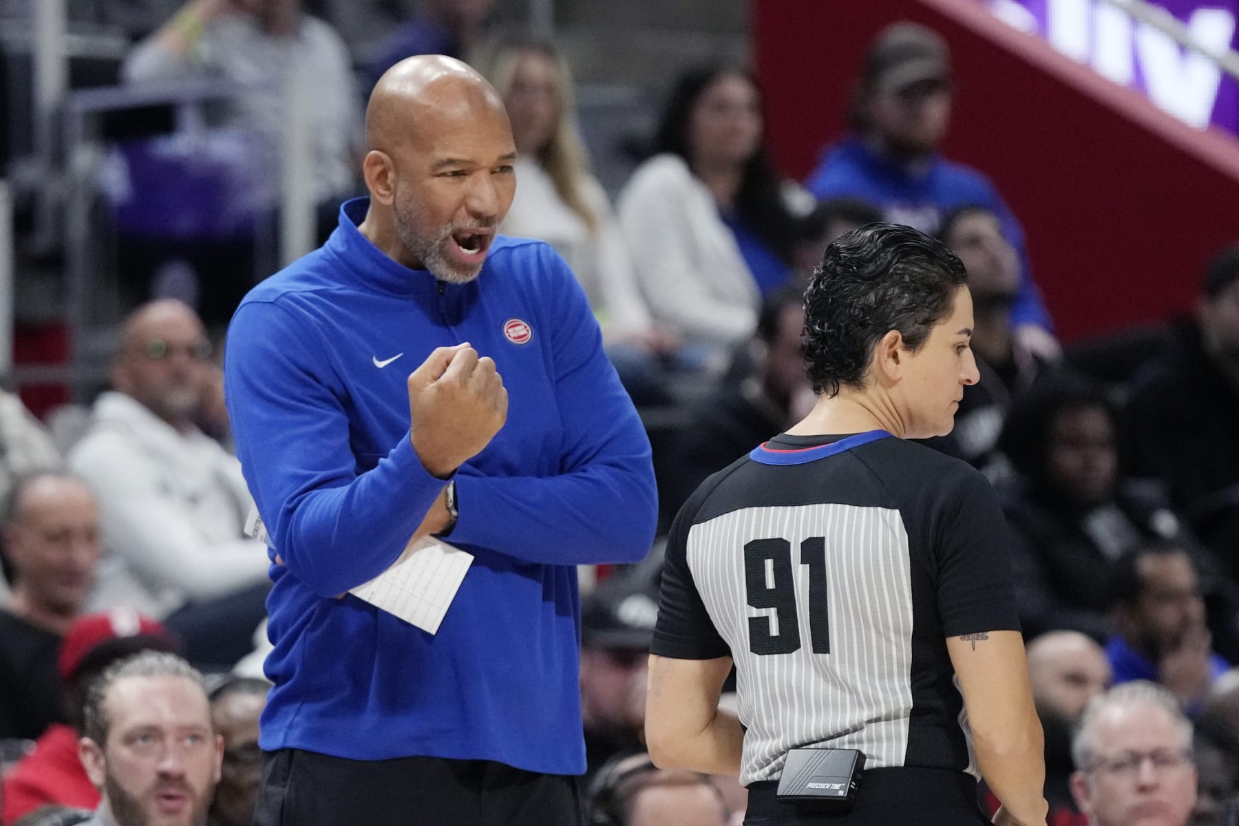 Detroit Pistons head coach Monty Williams talks with referee Che Flores during the first half of an NBA basketball game against the Washington Wizards, Monday, Nov. 27, 2023, in Detroit. (AP Photo/Carlos Osorio)