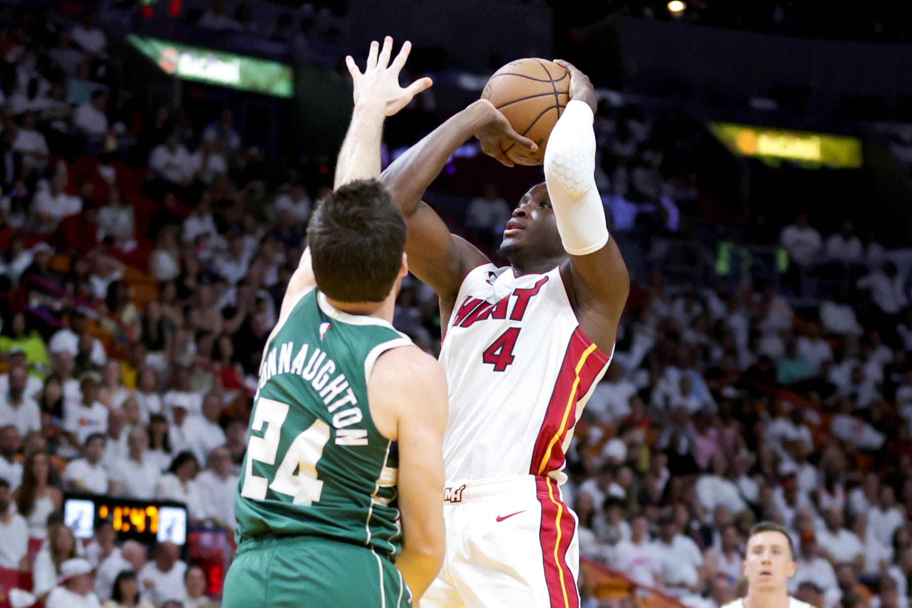 MIAMI, FLORIDA - APRIL 22: Victor Oladipo #4 of the Miami Heat shoots the ball against Pat Connaughton #24 of the Milwaukee Bucks during the second quarter in Game Three of the Eastern Conference First Round Playoffs at Kaseya Center on April 22, 2023 in Miami, Florida. NOTE TO USER: User expressly acknowledges and agrees that, by downloading and or using this photograph, User is consenting to the terms and conditions of the Getty Images License Agreement. (Photo by Megan Briggs/Getty Images)