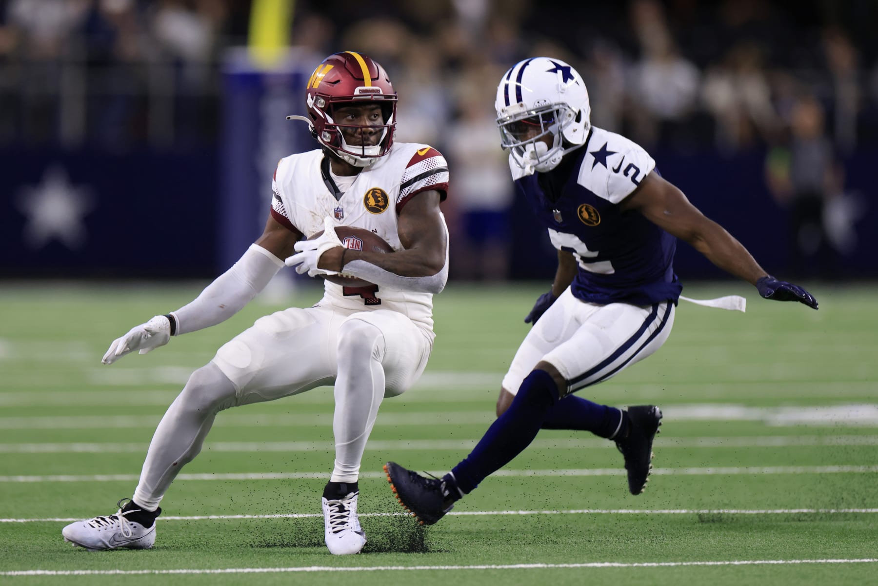 ARLINGTON, TEXAS - NOVEMBER 23: Curtis Samuel #4 of the Washington Commanders runs the ball while defended by Jourdan Lewis #2 of the Dallas Cowboys during the third quarter at AT&T Stadium on November 23, 2023 in Arlington, Texas. (Photo by Ron Jenkins/Getty Images) ARLINGTON, TEXAS - NOVEMBER 23: Curtis Samuel #4 of the Washington Commanders runs the ball while defended by Jourdan Lewis #2 of the Dallas Cowboys during the third quarter at AT&T Stadium on November 23, 2023 in Arlington, Texas. (Photo by Ron Jenkins/Getty Images)