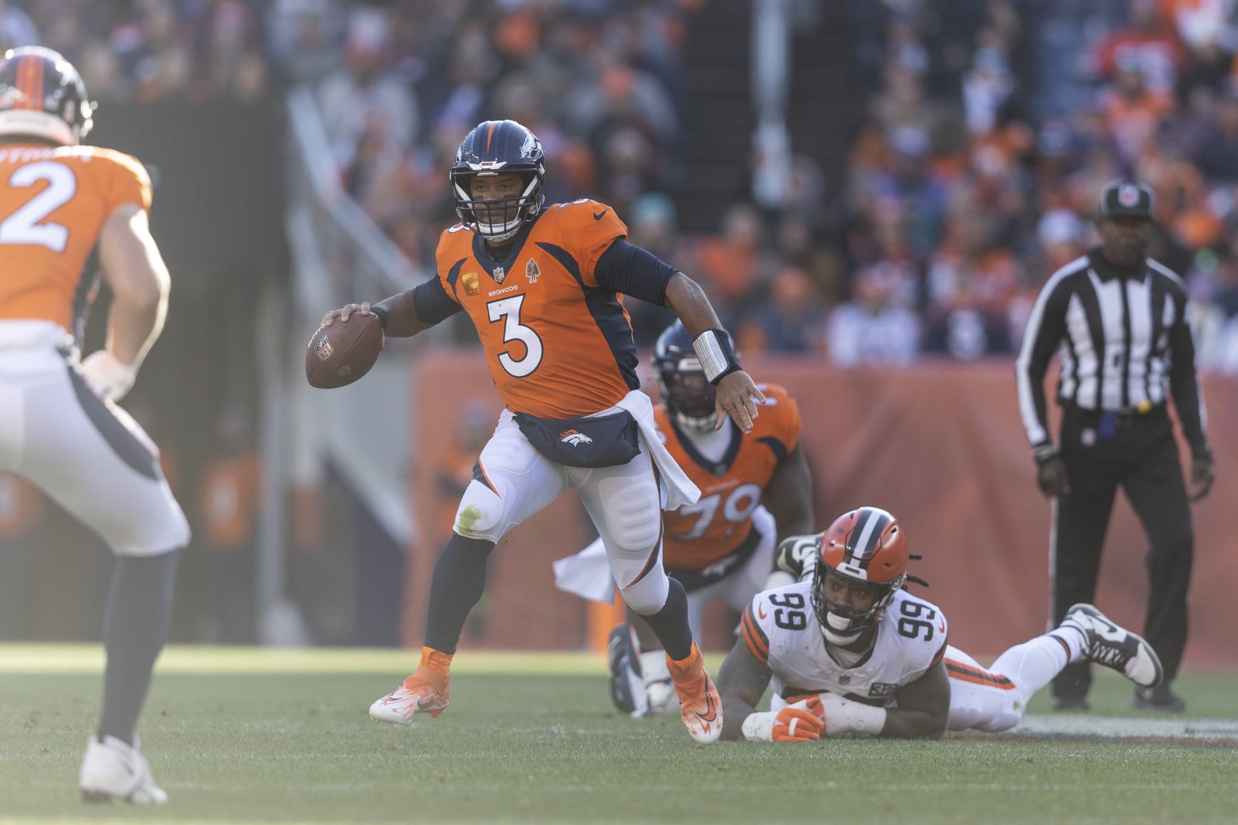 DENVER, COLORADO - NOVEMBER 26: Russell Wilson #3 of the Denver Broncos scrambles and runs with the ball during an NFL football game between the Denver Broncos and the Cleveland Browns at Empower Field At Mile High on November 26, 2023 in Denver, Colorado. (Photo by Michael Owens/Getty Images)