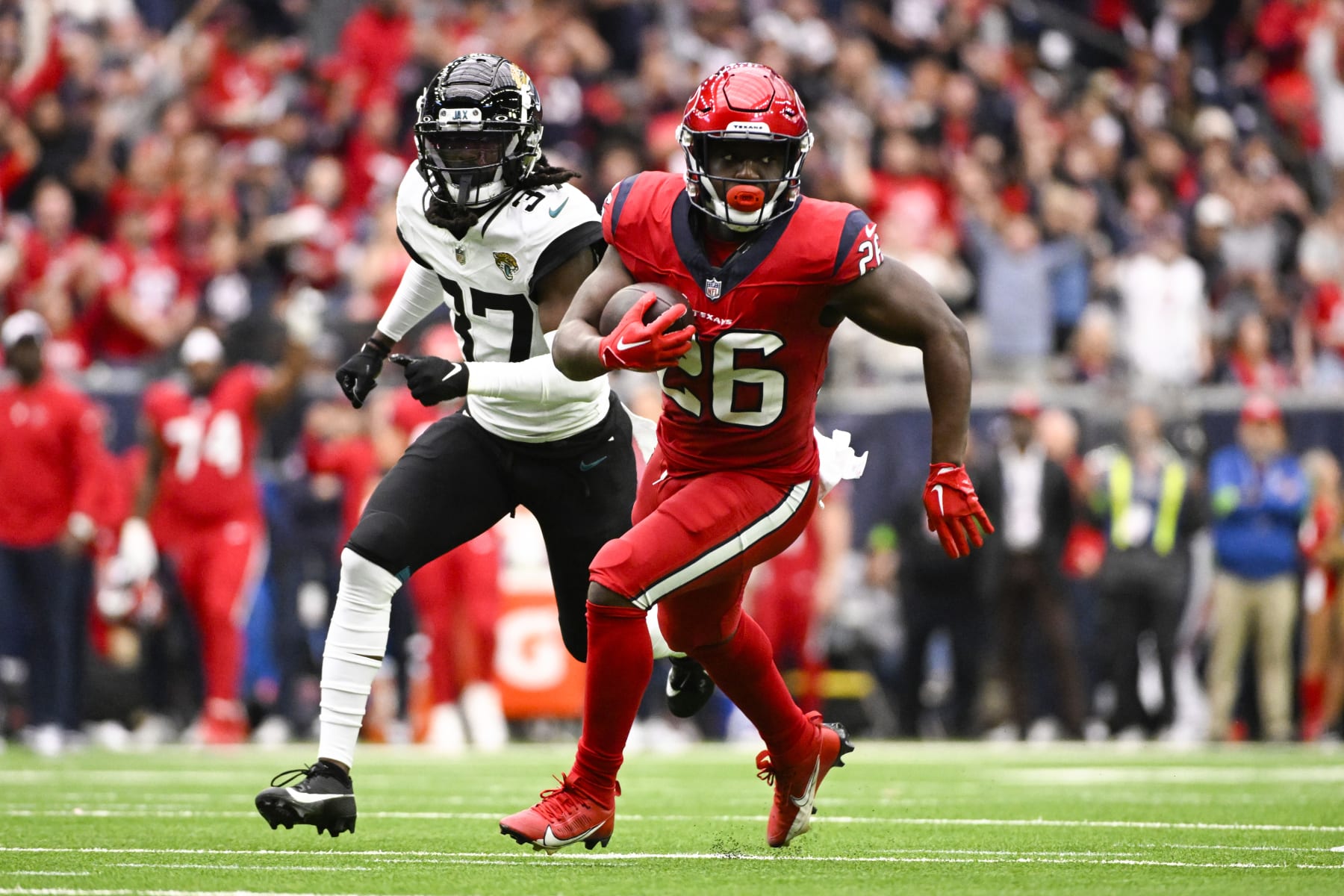 HOUSTON, TEXAS - NOVEMBER 26: Devin Singletary #26 of the Houston Texans runs with the ball during the first half of a game against the Jacksonville Jaguars at NRG Stadium on November 26, 2023 in Houston, Texas. (Photo by Logan Riely/Getty Images)