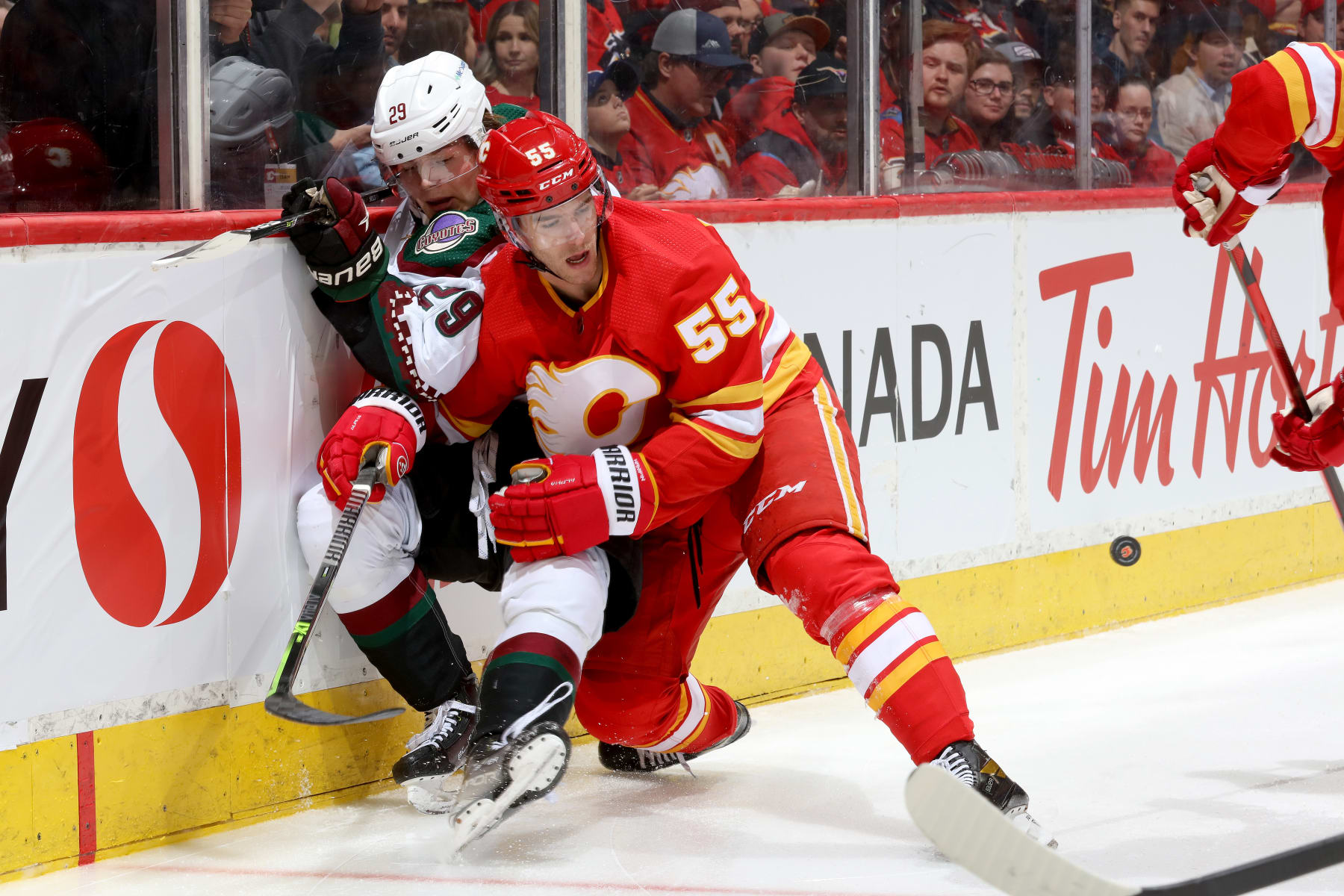 CALGARY, ALBERTA - APRIL 16: Noah Hanifin #55 of the Calgary Flames skates against Barrett Hayton #29 of the Arizona Coyotes at Scotiabank Saddledome on April 16, 2022 in Calgary, Alberta. (Photo by Gerry Thomas/NHLI via Getty Images)