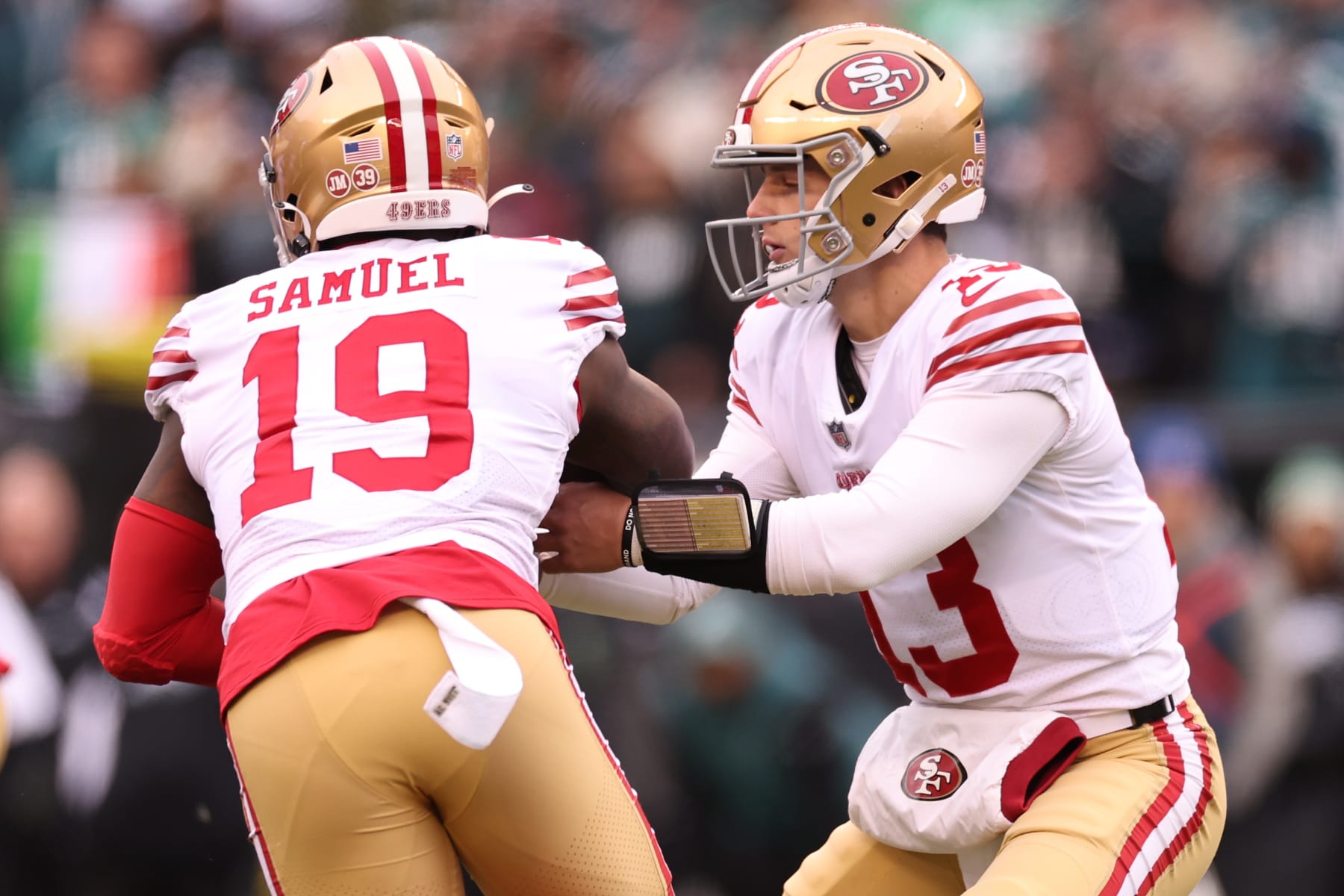 PHILADELPHIA, PENNSYLVANIA - JANUARY 29: Brock Purdy #13 of the San Francisco 49ers hands the ball off to Deebo Samuel #19 against the Philadelphia Eagles during the first quarter in the NFC Championship Game at Lincoln Financial Field on January 29, 2023 in Philadelphia, Pennsylvania. (Photo by Tim Nwachukwu/Getty Images)