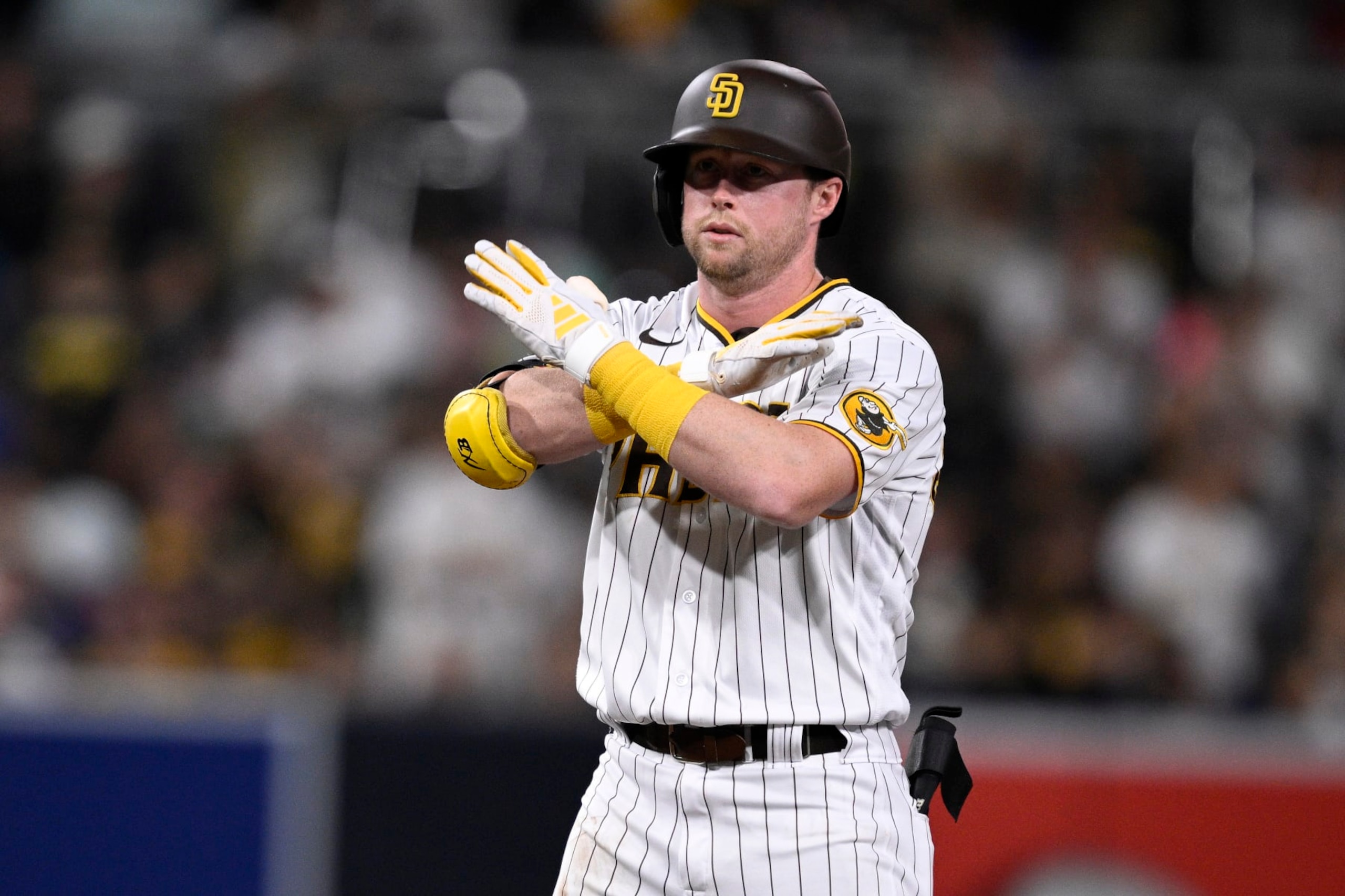 SAN DIEGO, CALIFORNIA - AUGUST 17: Jake Cronenworth #9 of the San Diego Padres gestures after hitting a double against the Arizona Diamondbacks during the fifth inning at PETCO Park on August 17, 2023 in San Diego, California. (Photo by Orlando Ramirez/Getty Images)