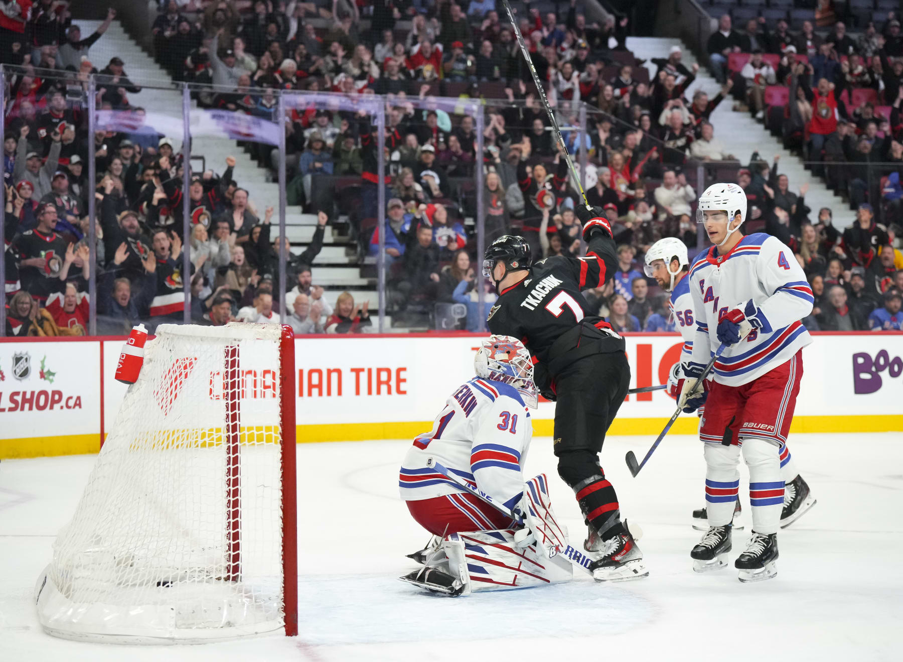 OTTAWA, CANADA - DECEMBER 5: Brady Tkachuk #7 of the Ottawa Senators celebrates his first-period goal against Igor Shesterkin #31 of the New York Rangers as Braden Schneider #4 looks on during at Canadian Tire Centre on December 5, 2023 in Ottawa, Ontario, Canada. (Photo by André Ringuette/NHLI via Getty Images)