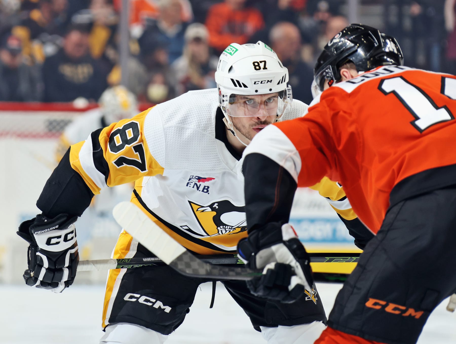PHILADELPHIA, PENNSYLVANIA - DECEMBER 04: Sidney Crosby #87 of the Pittsburgh Penguins prepares for a faceoff with Sean Couturier #14 of the Philadelphia Flyers at the Wells Fargo Center on December 4, 2023 in Philadelphia, Pennsylvania. (Photo by Len Redkoles/NHLI via Getty Images)